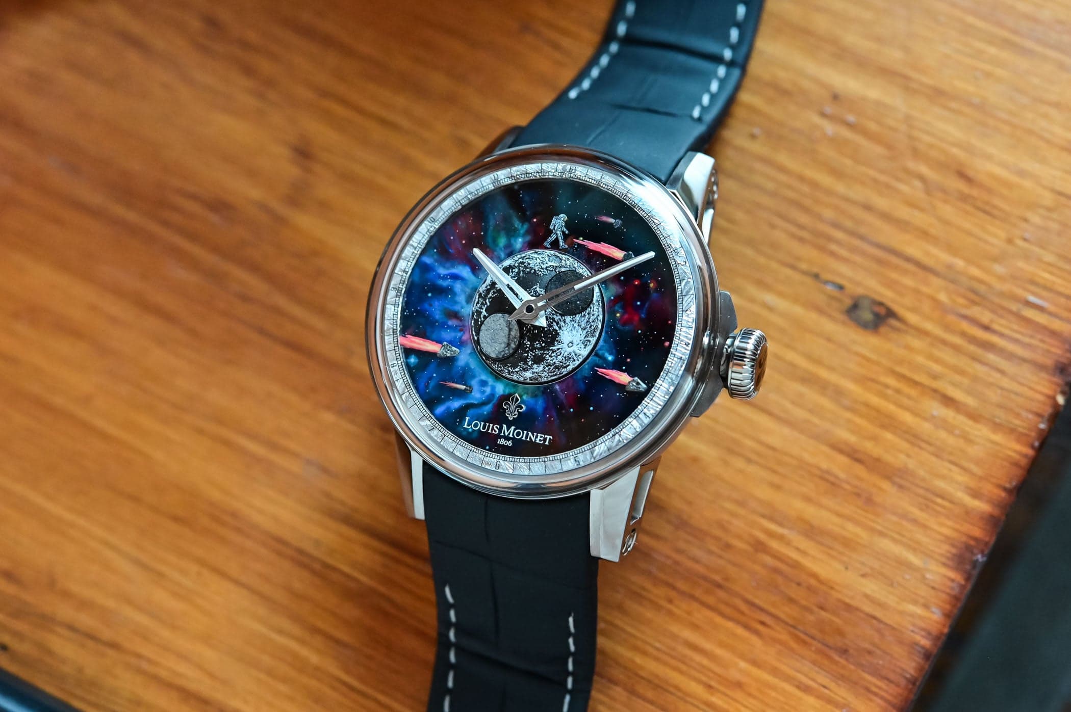 The Louis Moinet Moon Meteor in polished titanium, a hand-painted celestial dial with a domed lunar disc, a walking astronaut and meteorite fragments, on a black alligator strap