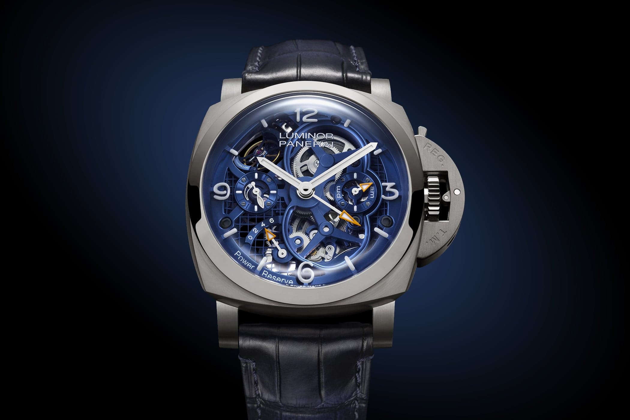The Panerai Luminor Tourbillon GMT Titanio PAM01784, a brushed grade 5 titanium cushion case with a blue skeletonised dial, an openworked tourbillon and the crown-protecting bridge, on a blue alligator strap