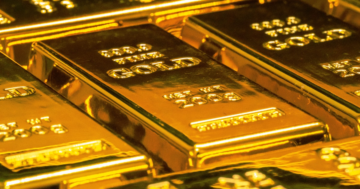 Gold bars and coins reflecting the precious metal market movement affecting watch pricing
