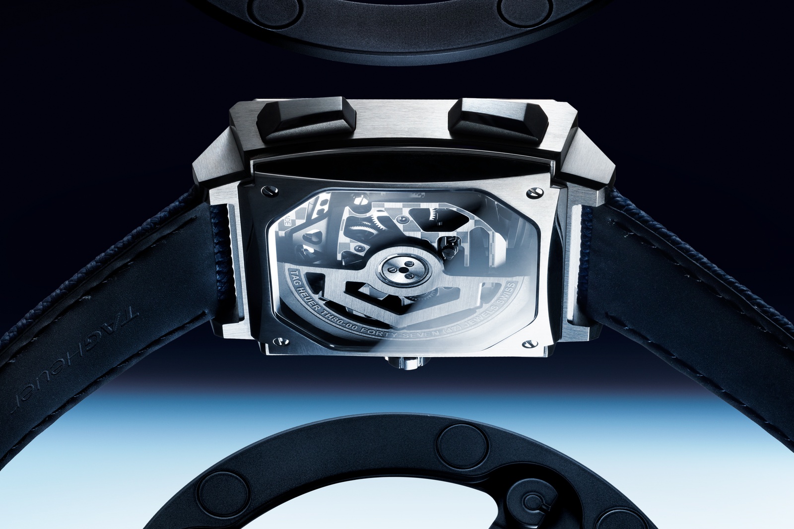 Caseback view of CEW5181 showing the sapphire reveal of Calibre TH80-00, with engraved TAG HEUER TH80-00 FORTY-SEVEN (47) JEWELS SWISS lettering around the rotor and visible gear train