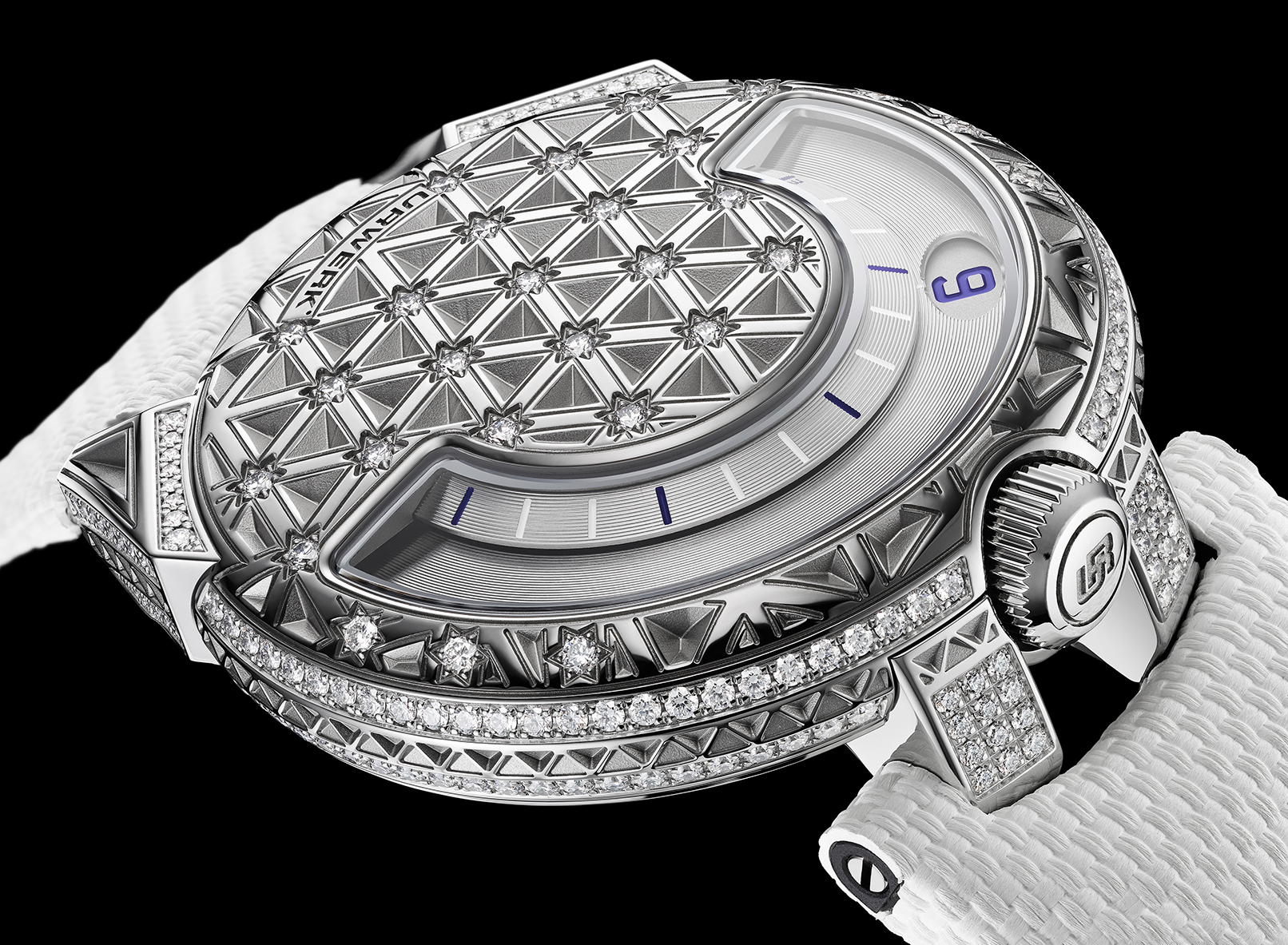 Urwerk UR-101 Diamond Sky from above, six-petal floret pattern engraved into the dome, rotating satellite hours wheel visible through the central aperture