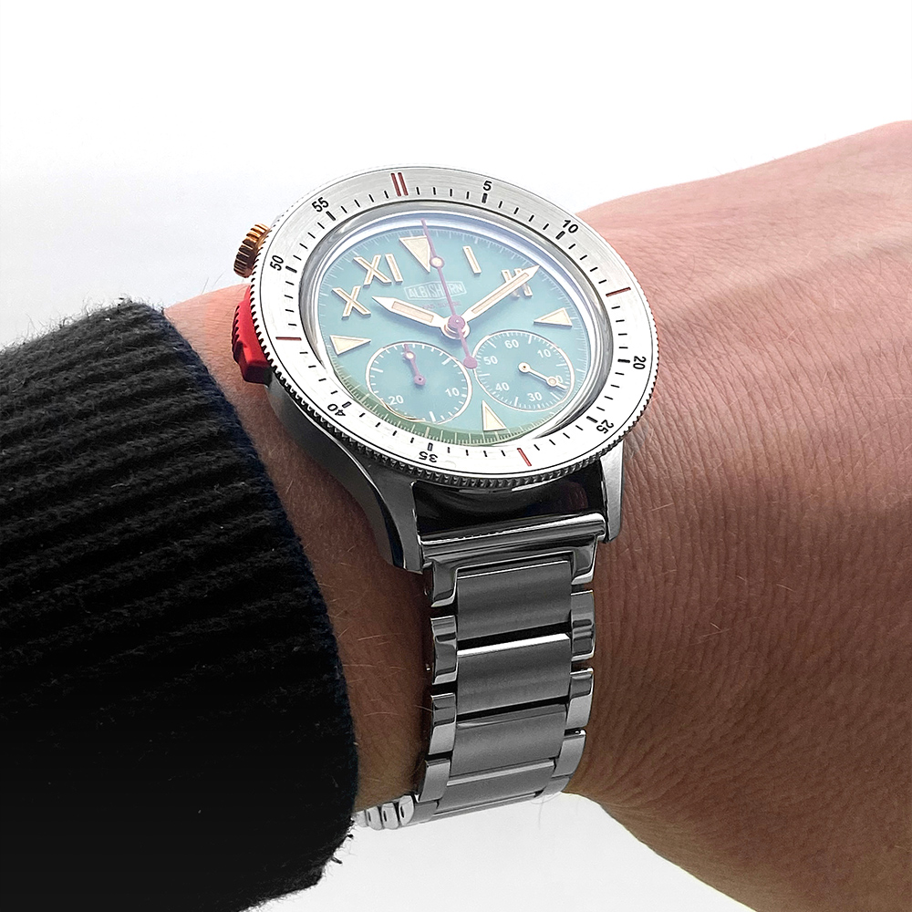 Thundergraph Khumbu dial macro showing the green sunburst finish, applied baton hour markers, white printed minute scale and 30-minute chronograph counter at 6