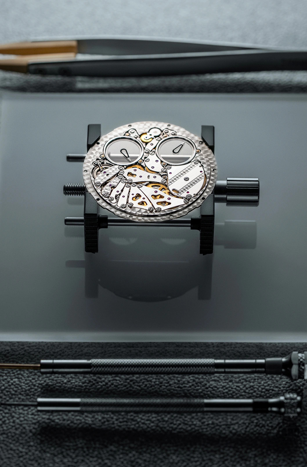 ThinKing Mystery on its black leather strap with elastic insert and titanium support tabs at the lugs, the strap engineered to sit flat against the wrist alongside the ultra-thin case