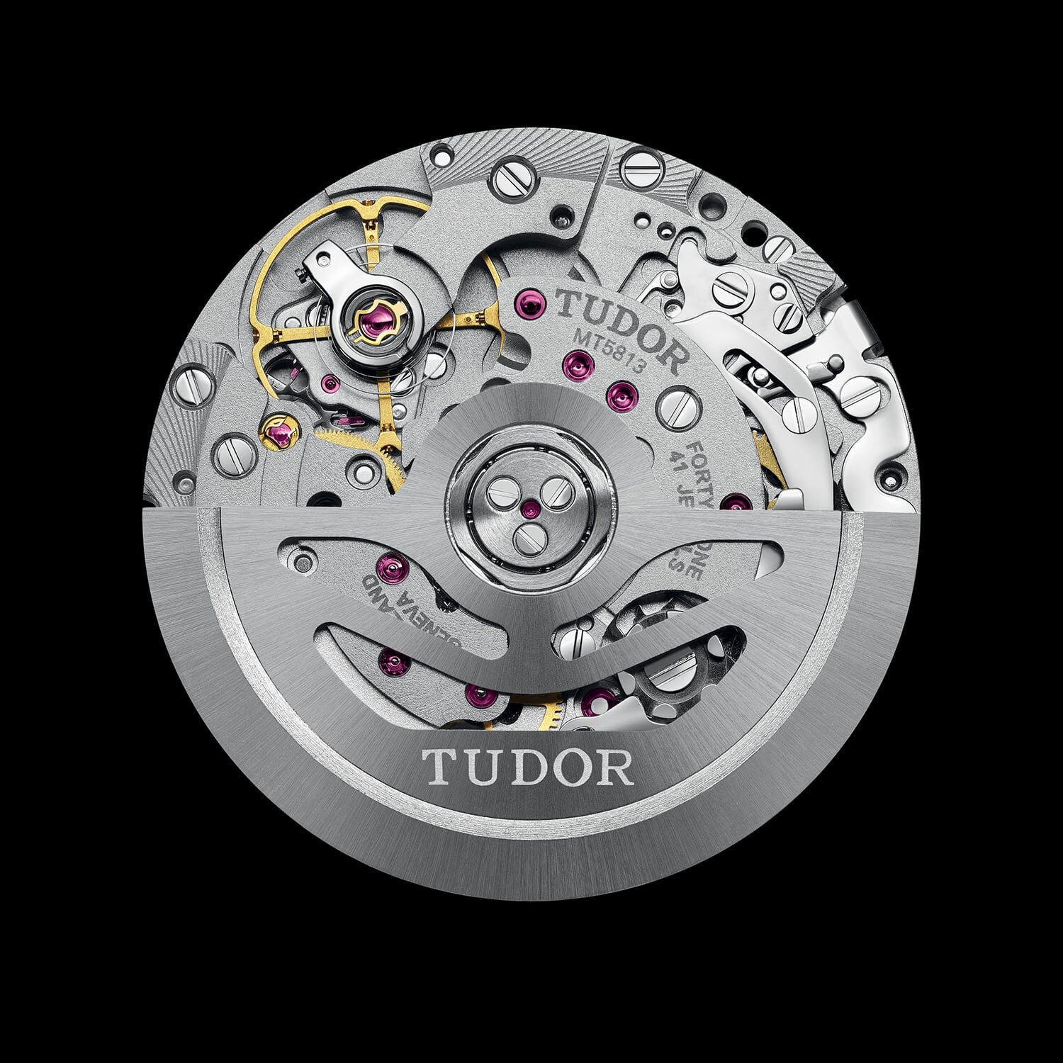 The Tudor Manufacture Calibre MT5813 automatic chronograph, built on the Breitling B01 architecture, shown from the rotor side with the TUDOR-engraved openworked rotor