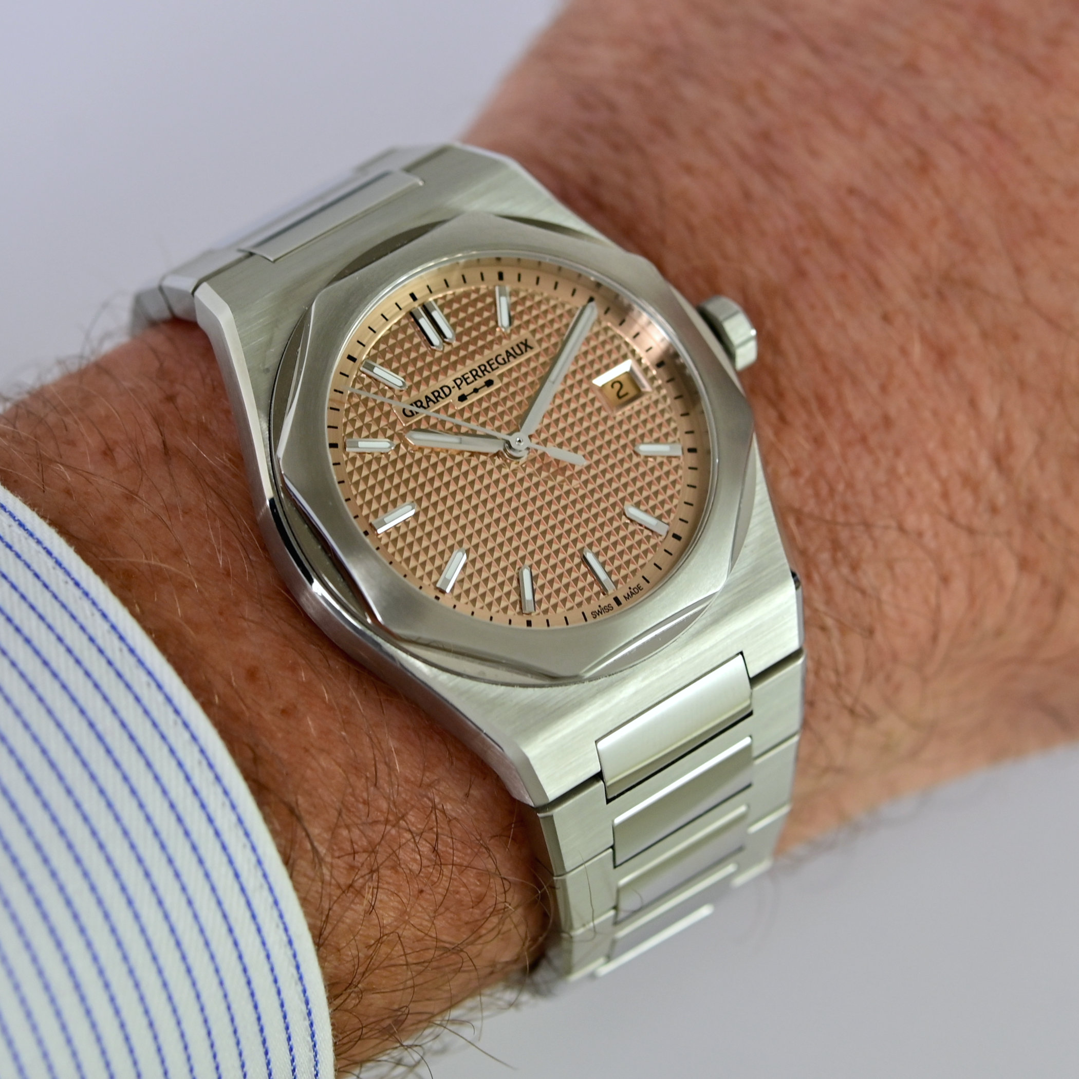 The 39mm Laureato Fifty with rose-gold-toned Clous de Paris dial and date at 3 o'clock worn on the wrist, brushed integrated steel bracelet with polished accents