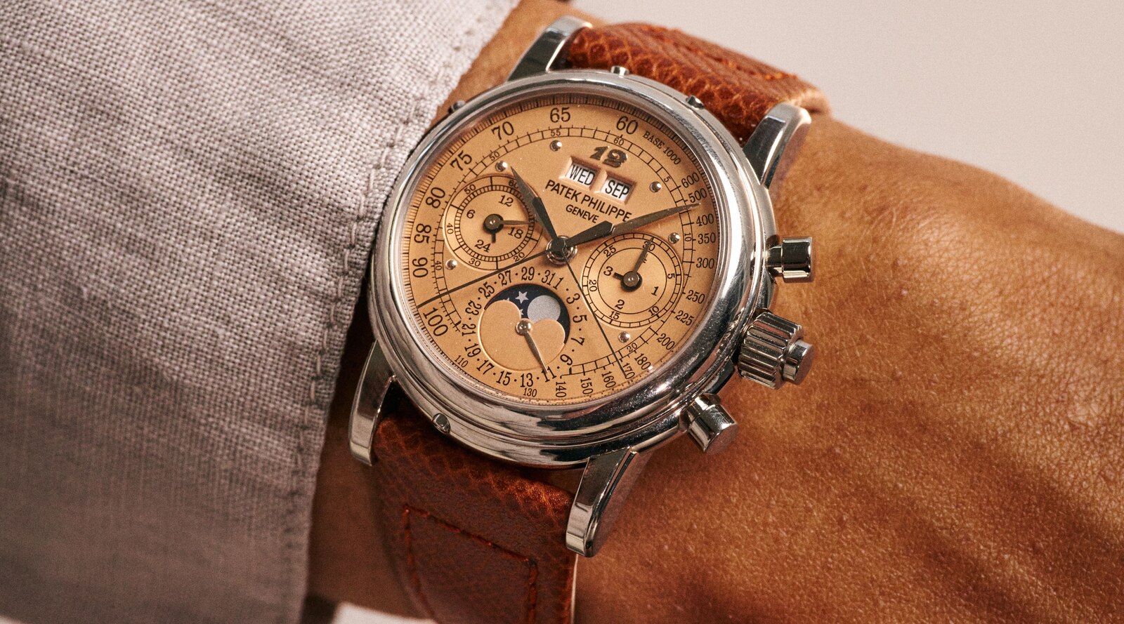 Eric Clapton's Patek Philippe reference 5004G-020 perpetual calendar split-seconds chronograph in white gold with rose dial, worn on a brown leather strap, lot 88 of the sale