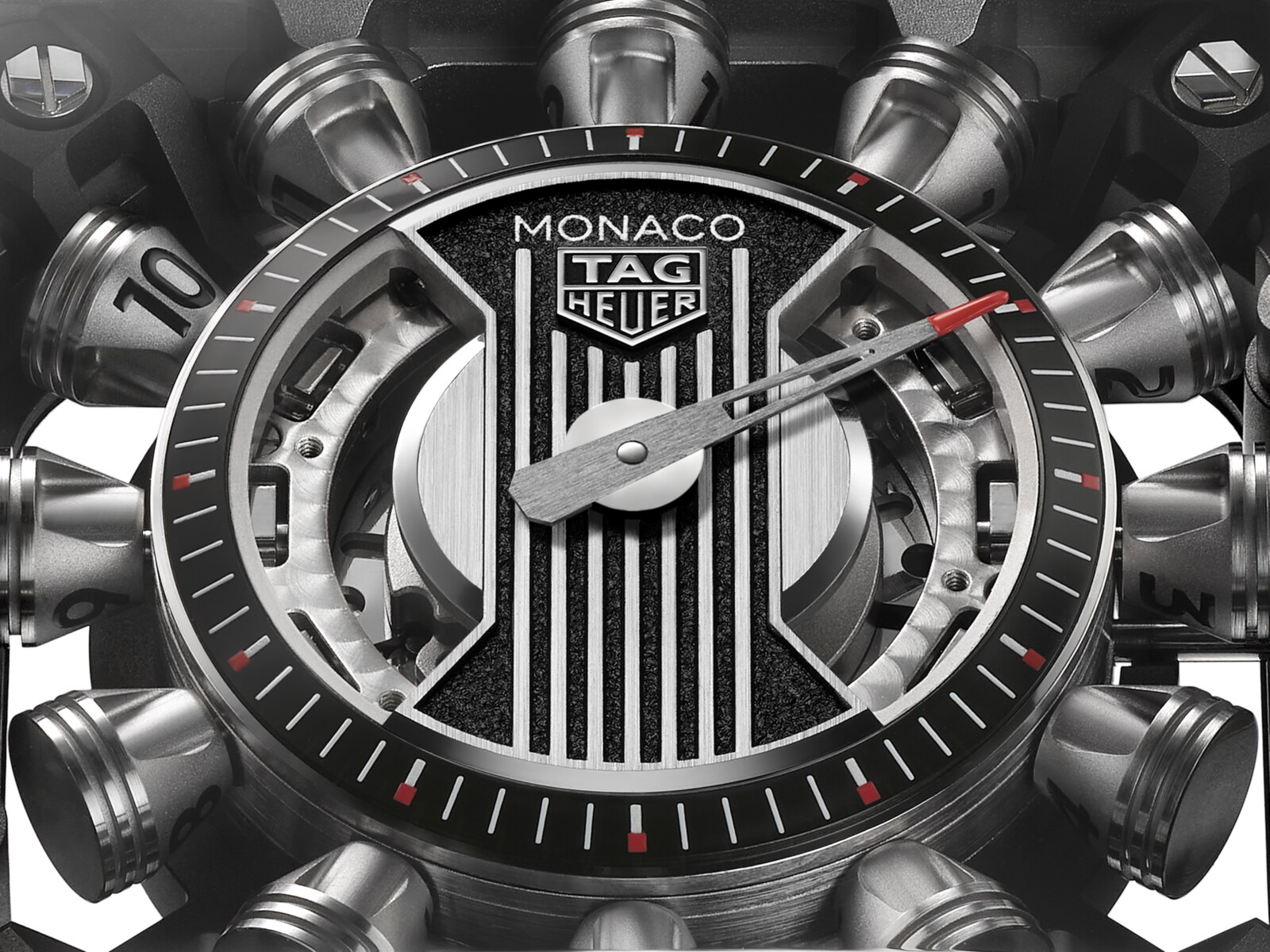Dial macro of the Monaco Speed 12 showing the grooved engine-cover centre, the skeletonised red-tipped minutes hand, the black opaline minute ring and the titanium hour pistons with black lacquered numerals