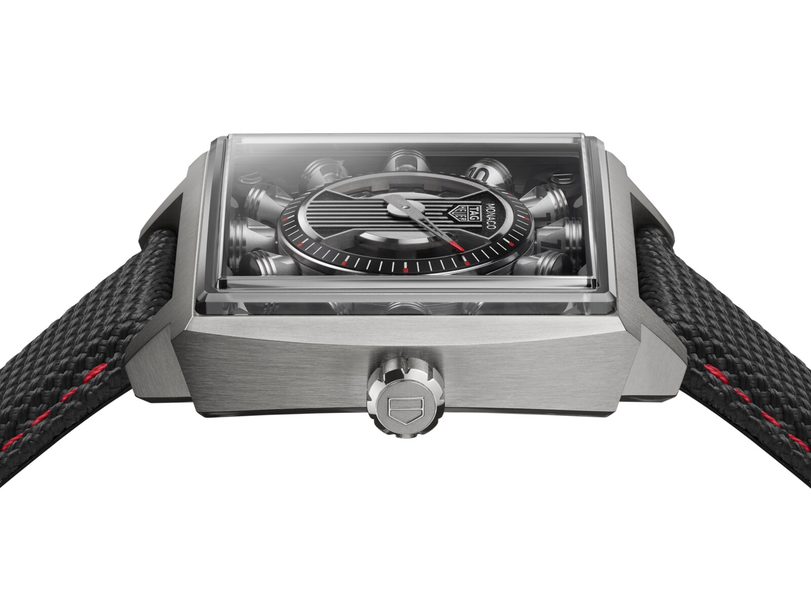 Side profile of the 40mm Grade 5 titanium case showing the domed sapphire crystal, the height of the piston mechanism beneath it and the fluted crown with the TAG Heuer shield