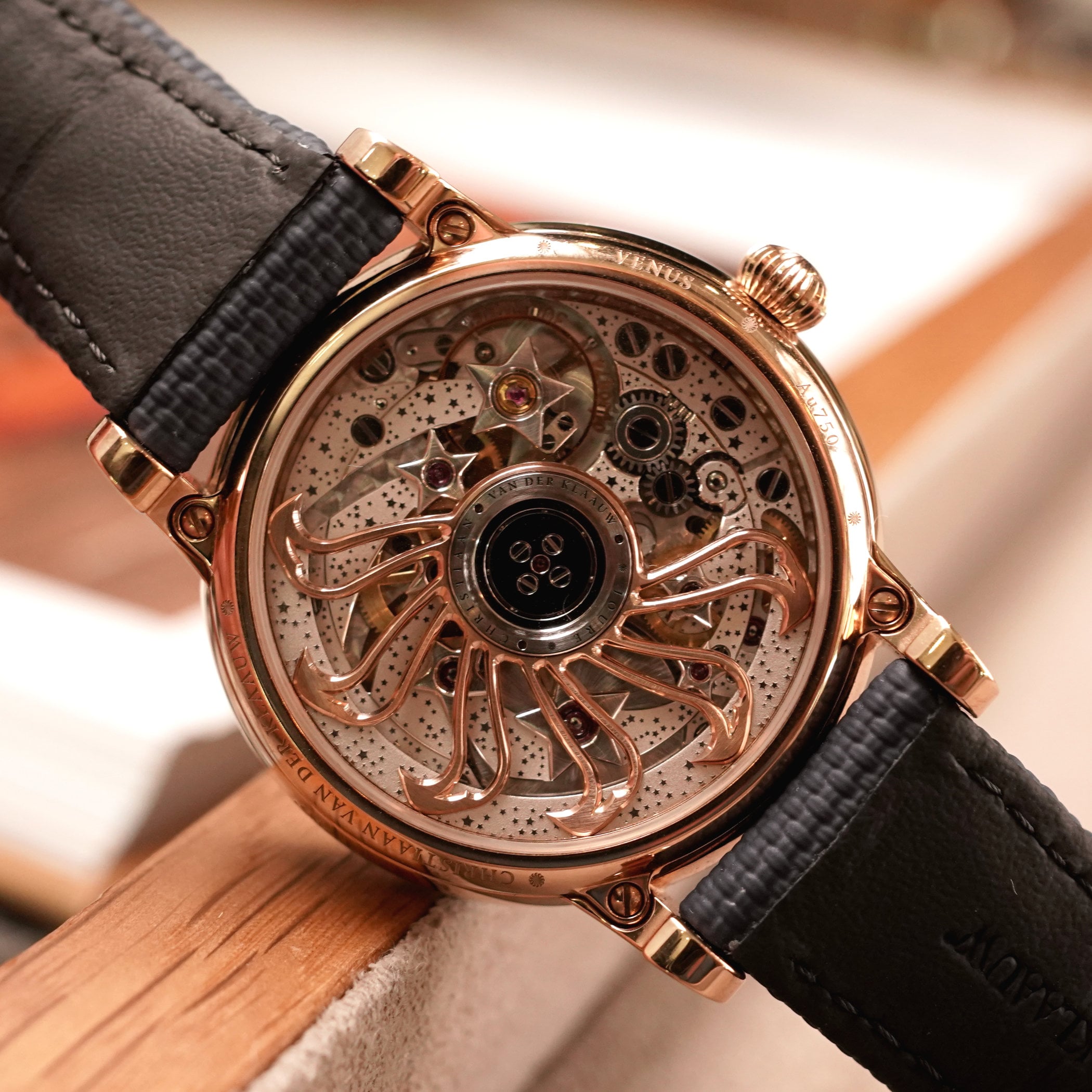 Caseback of the Venus Zodiac showing the CKM-01 calibre, skeletonised sun-shaped rotor in rose gold tone, star-embossed bridges and VENUS engraved on the case ring