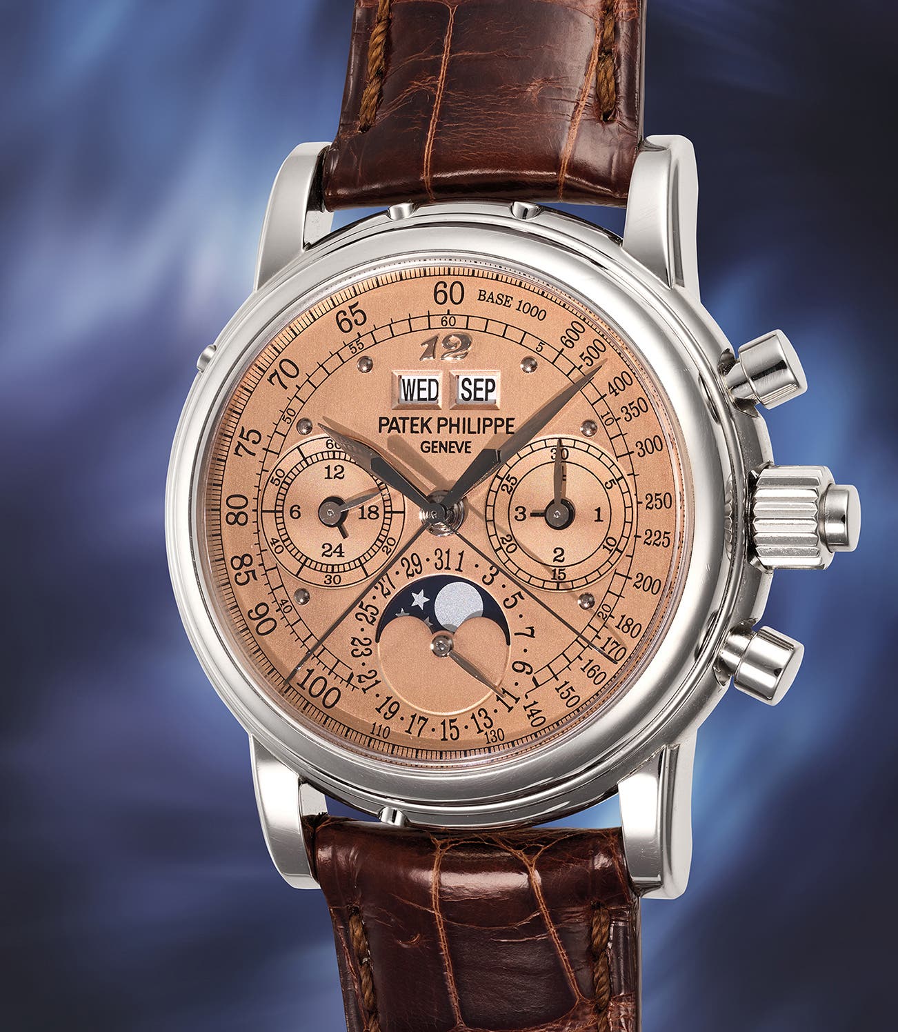 Patek Philippe reference 5004G-020 'Eric Clapton', 18-karat white gold split-seconds perpetual calendar chronograph, salmon 'rose' dial with Breguet numeral 12, day and month windows, moon phase and tachymeter scale, on a brown crocodile strap