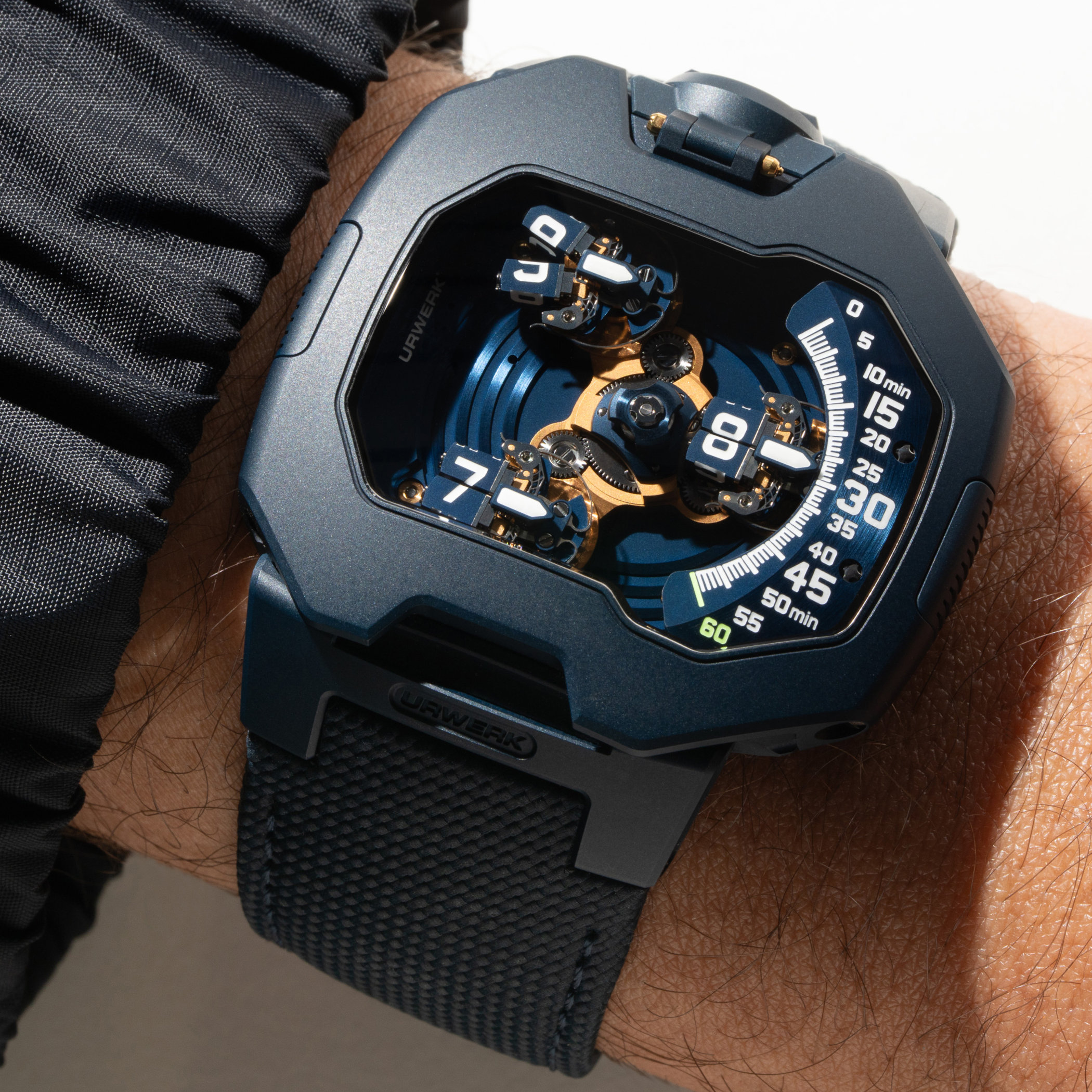 Top-down view of the UR-120 Blue Planet dial, blue carousel carrying the white luminous hour cubes, a gold-plated central mechanism and the curved minute scale running from zero to sixty with a green sixty marker