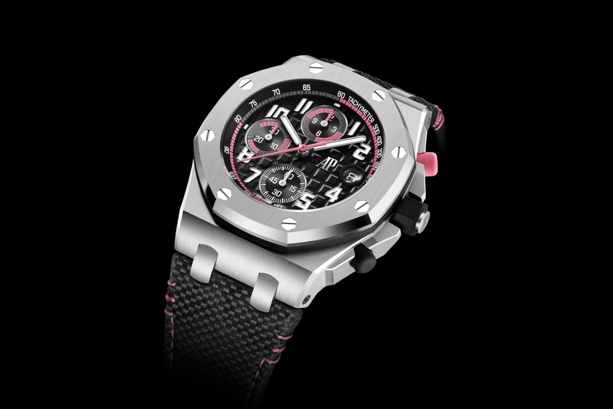 Audemars Piguet Royal Oak Offshore Selfwinding Chronograph 42mm in steel at a three-quarter angle, black Méga Tapisserie dial with pink accents and a pink chronograph pusher, on a black textile strap with pink stitching
