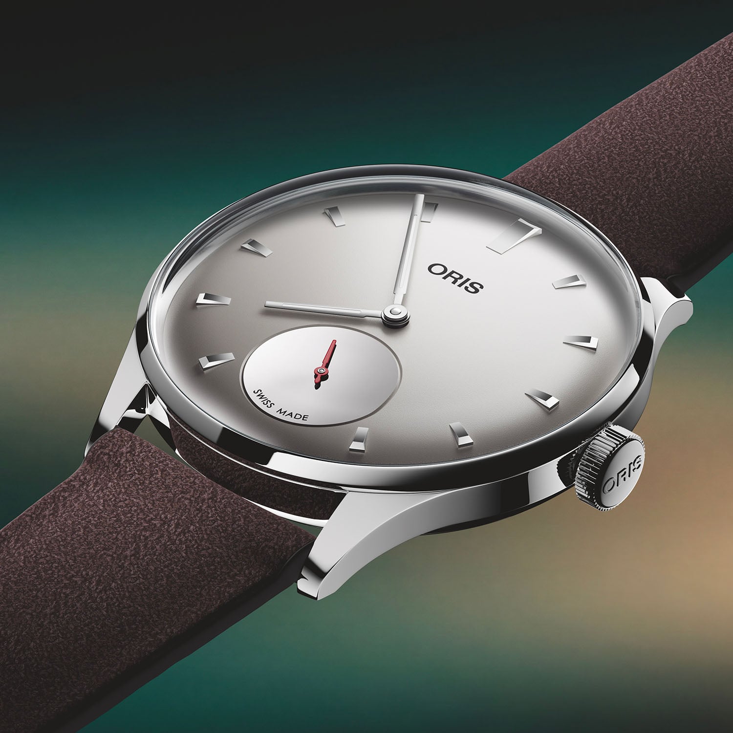 Side profile of the Oris Hölstein Edition 2026, polished multi-piece steel case with the ORIS-signed crown, light grey dial and brown suede strap