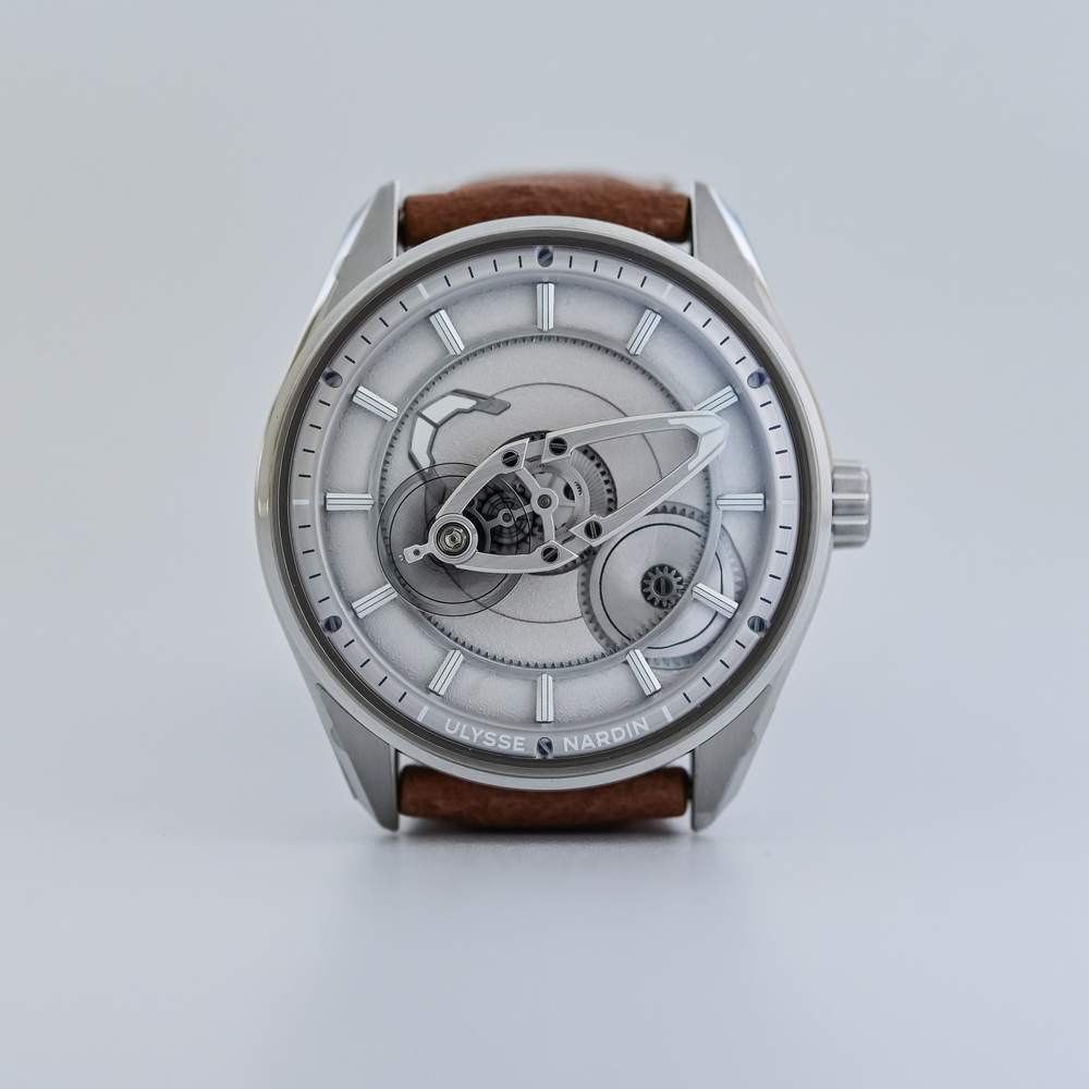 Ulysse Nardin Freak X 2026 Grey, reference 2323-500-1A/0A, grey sandblasted hour disc with applied luminous indices and the flying carousel, in an 80% recycled steel case on a light brown calfskin strap