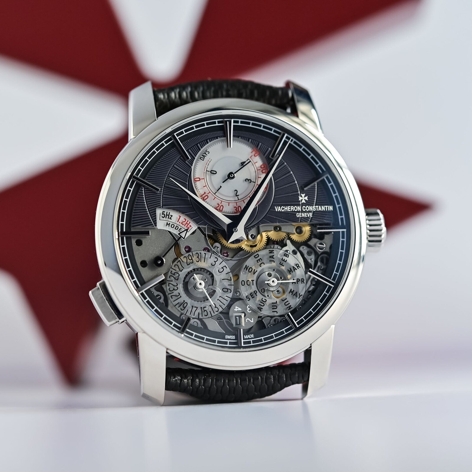 Front view of the Vacheron Constantin Twin Beat Perpetual Calendar dial, the upper slate-grey gold section carrying the DAYS power-reserve counter and 5Hz/1.2Hz MODE selector, the lower half open through sapphire to the perpetual calendar's day and month sub-dials