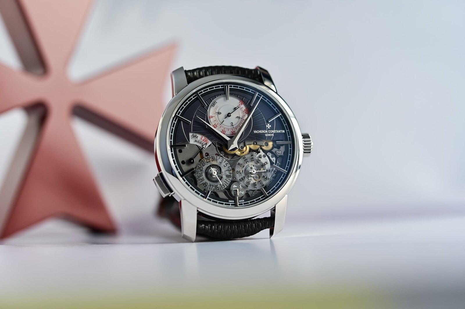 Vacheron Constantin Traditionnelle Twin Beat Perpetual Calendar ref. 3200T in platinum, a slate-grey guilloche upper dial carrying a DAYS power-reserve scale and a 5Hz/1.2Hz mode selector above an open sapphire lower half, on a black strap beside a red Maltese cross