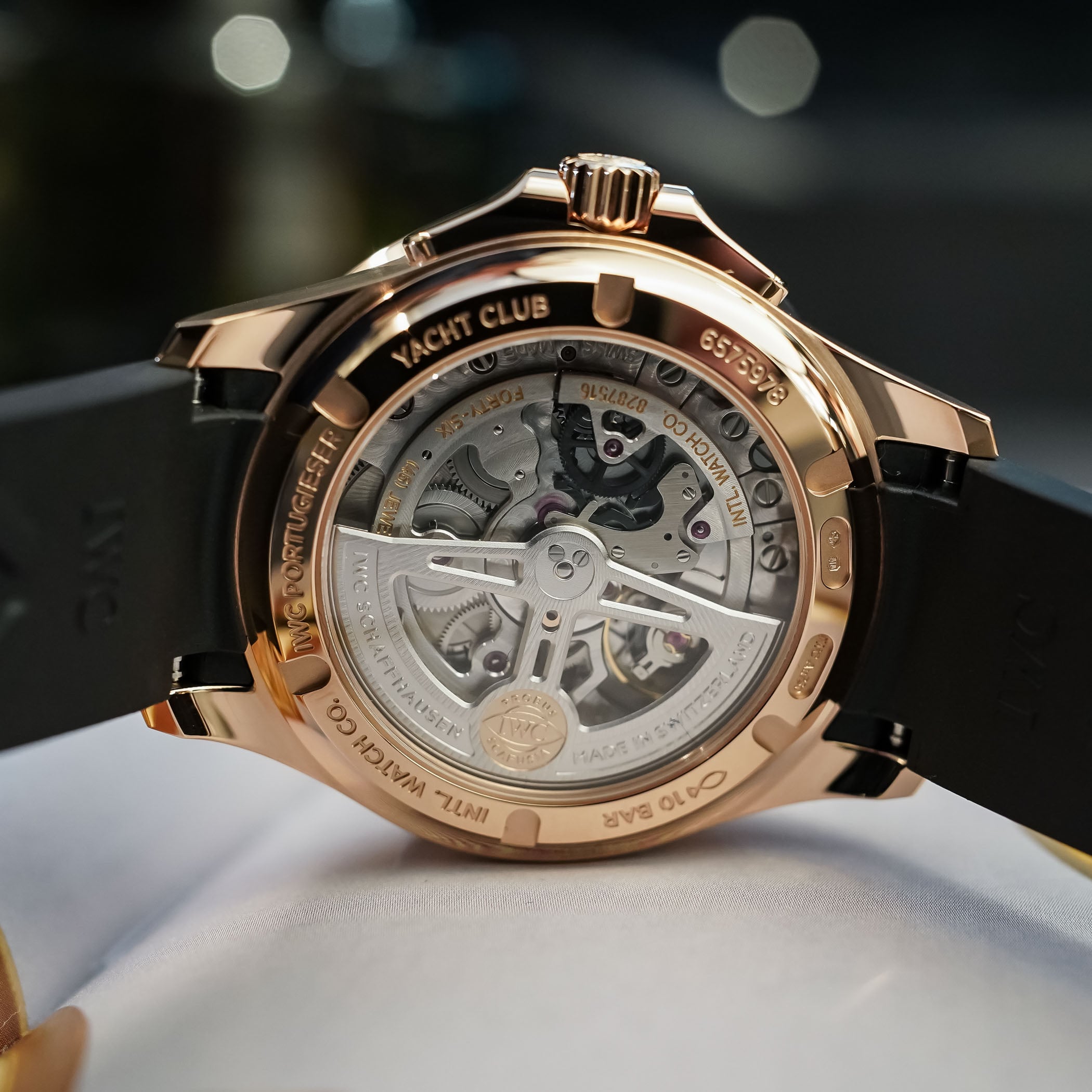 Caseback of the IWC Portugieser Yacht Club Perpetual Calendar 42, the Armor Gold ring engraved YACHT CLUB and IWC PORTUGIESER around a sapphire window onto the calibre 82651 with its skeletonised Pellaton winding rotor and Probus Scafusia medallion