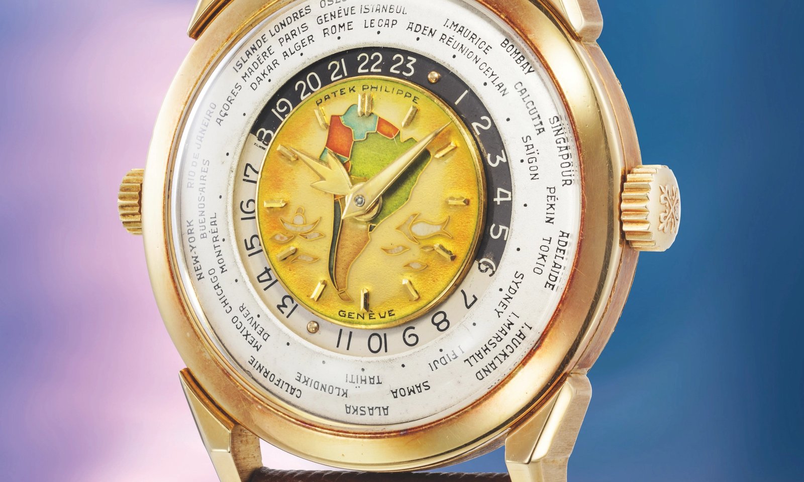 Patek Philippe reference 2523 two-crown world time in yellow gold, cloisonné enamel centre dial depicting a map, silvered city ring listing world cities and 24-hour ring, sold for $10.2m at Phillips in May 2026
