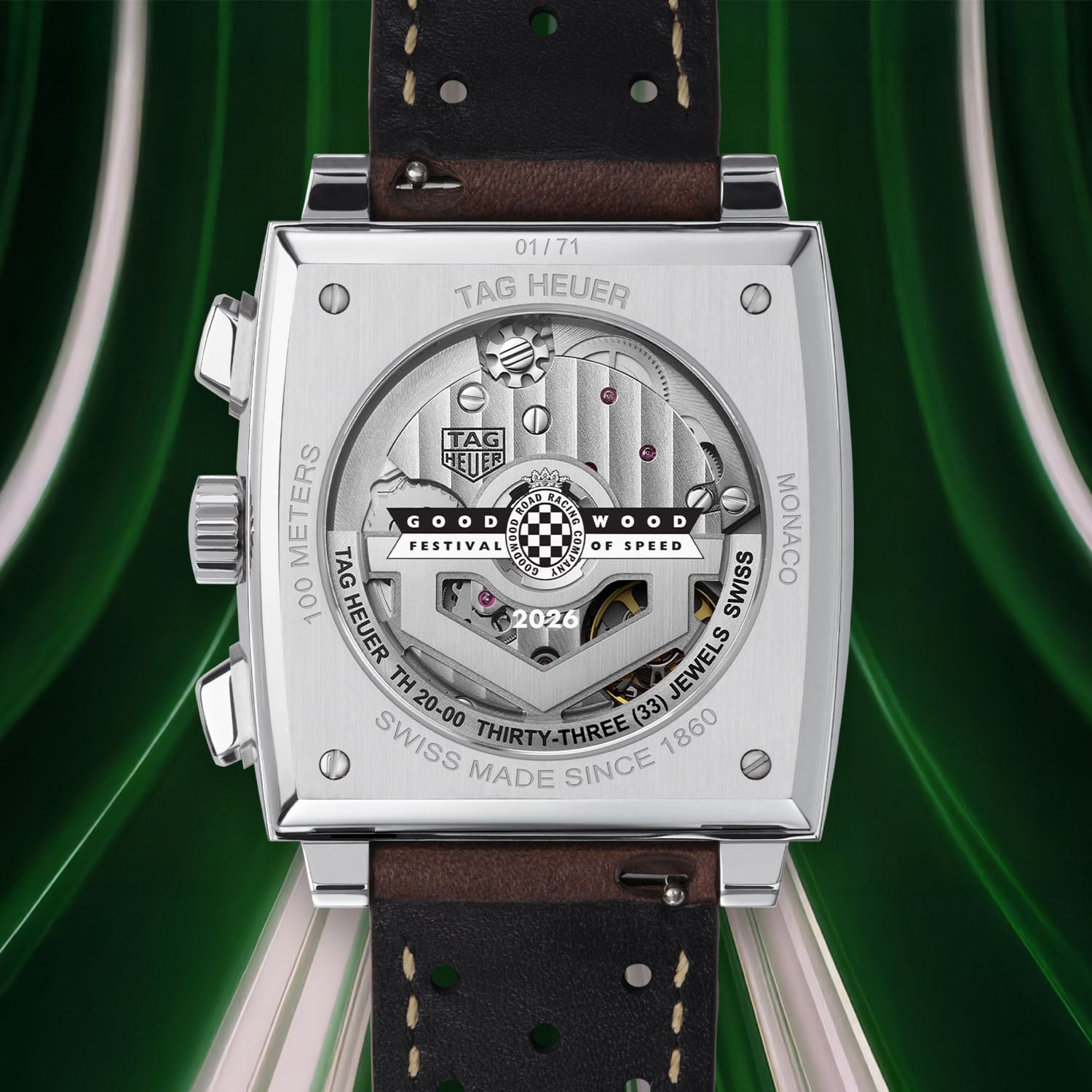 Caseback of the Monaco x Goodwood 2026 numbered 01/71, sapphire window with the Goodwood Festival of Speed logo printed over the TH20-00 rotor, TAG HEUER MONACO and 100 METERS engraved on the steel ring