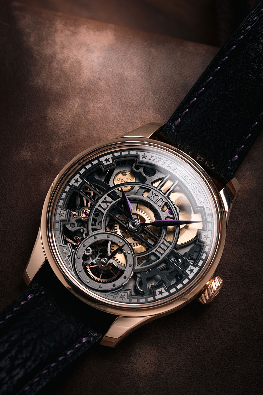 1776 Atelier Liberty 250, 41mm 18k rose gold case with polished bezel, openworked grey movement visible through the front sapphire with No.03 engraved on a gold plaque, plum-coloured hands, Roman numerals and star-shaped markers, on a black leather strap with purple stitching