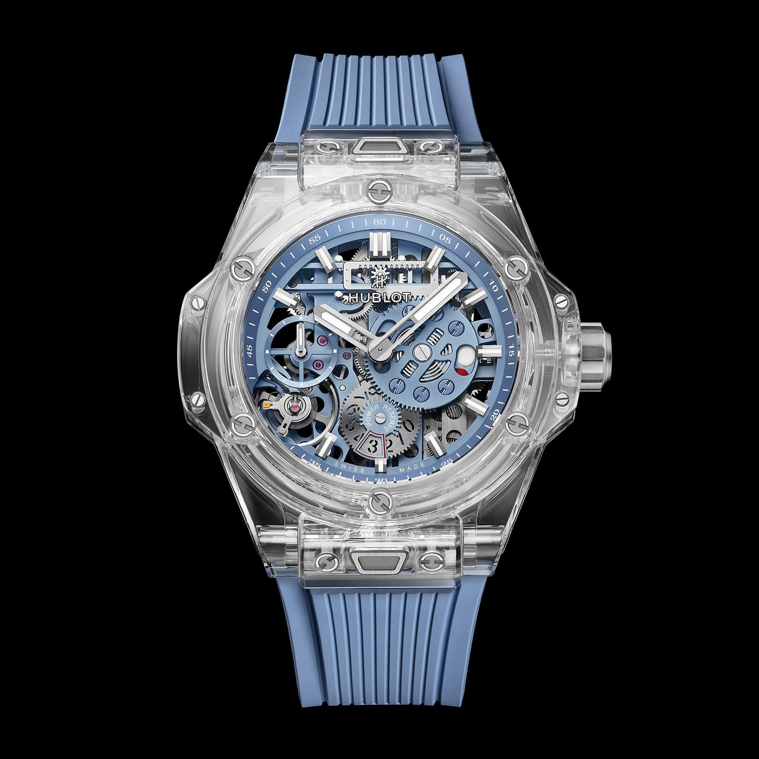 Straight-on studio view of the Hublot Big Bang Sapphire Sky Blue on black, showing the transparent sapphire case and bezel with H-shaped titanium screws, matte sky-blue skeleton dial, the POWER RESERVE scale at 6 o'clock and the sky-blue ribbed rubber strap