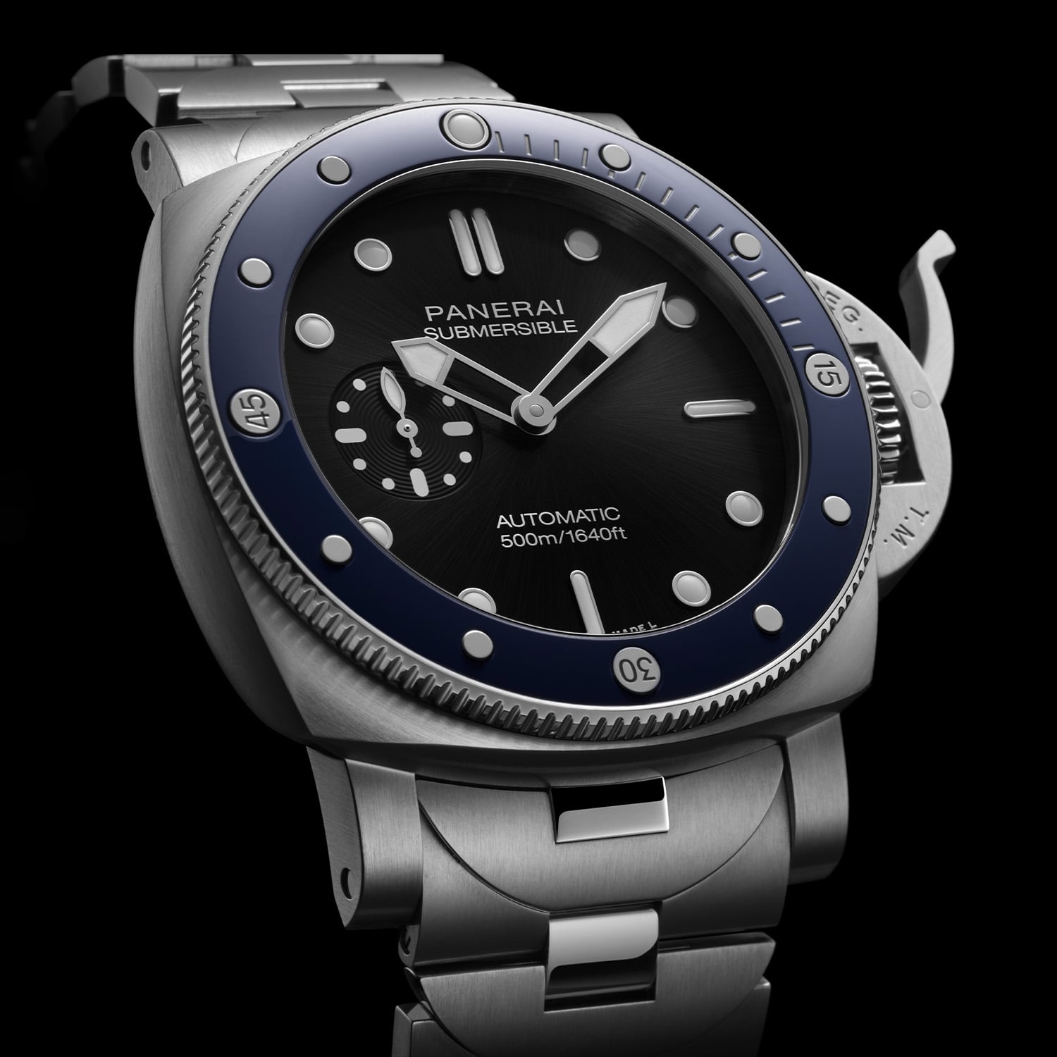 Three-quarter studio view of the Panerai Submersible PAM01756 on black, showing the brushed 44mm steel cushion case, blue polished ceramic bezel with luminous markers, black sunbrushed dial with small seconds at 9 and the crown lever guard