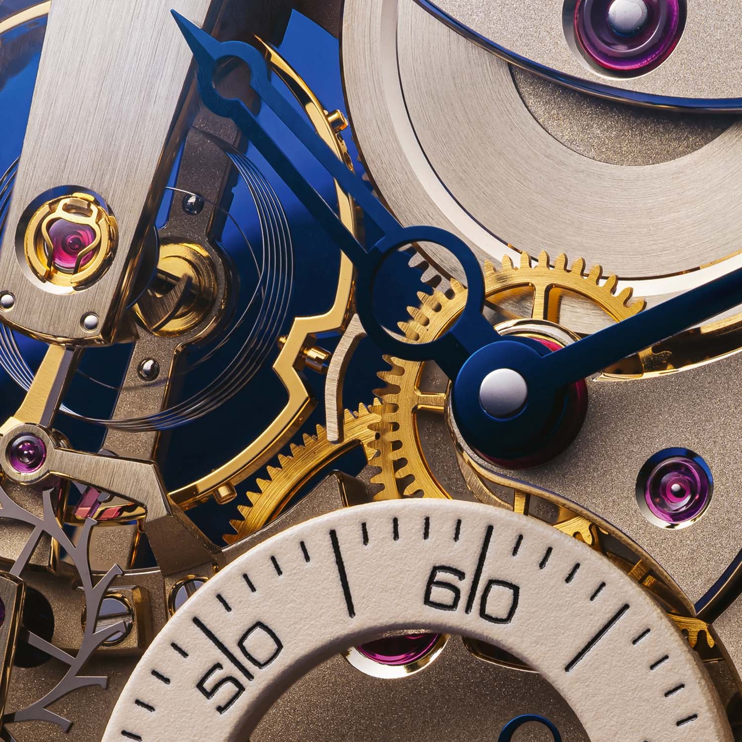 Macro of the FB 3SPC.2-1 dial side, sandblasted nickel silver plates with gilded gear train, ruby jewels in gold chatons, blue CVD-treated skeletonised hands and the edge of the beige small seconds subdial