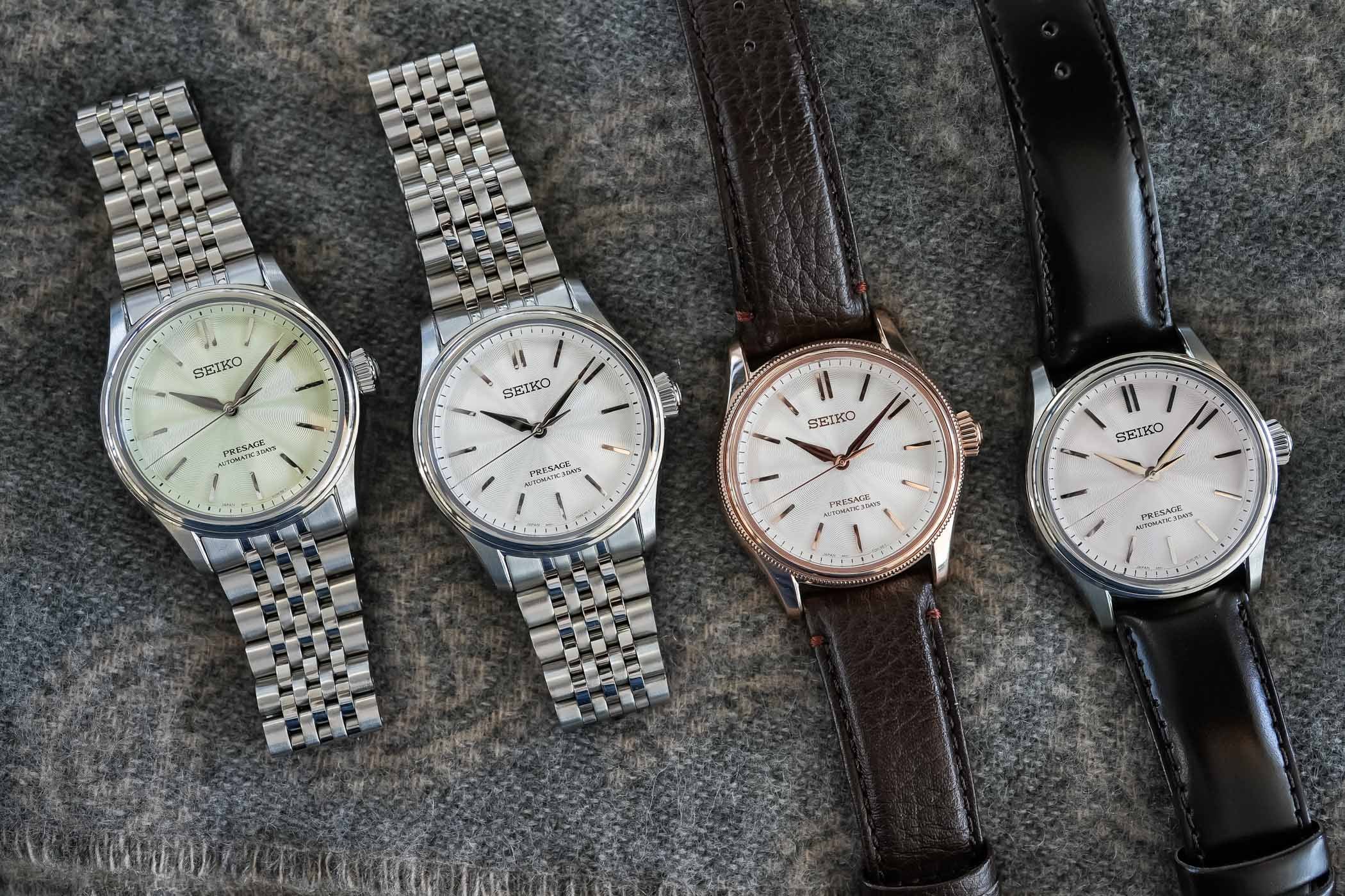 The four new 38mm Seiko Presage Classic Series references laid on grey wool: HCC002 with wakatake-iro green dial on steel bracelet, HCC001 with shironeri white dial on steel bracelet, the limited HCC008 with pearl-coated white dial in a pink-gold-plated case with beaded bezel on brown leather, and HCC003 with sakura-iro pink dial on dark leather