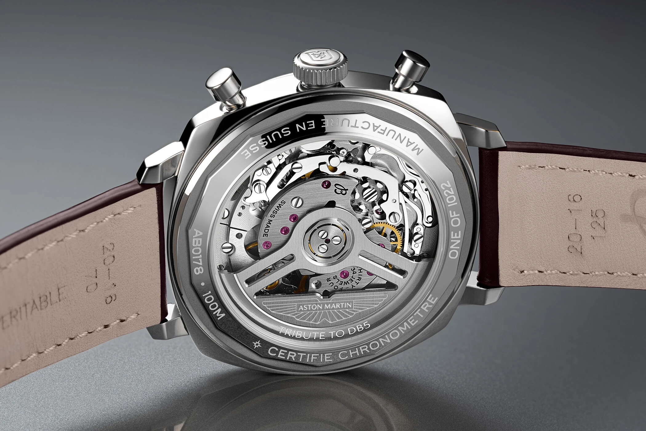 Sapphire caseback of the steel Top Time DB5 showing the Breitling B01 automatic movement, the Aston Martin wings engraved on the rotor bridge, and the engravings AB0178, 100M, ONE OF 1022, CERTIFIE CHRONOMETRE and TRIBUTE TO DB5