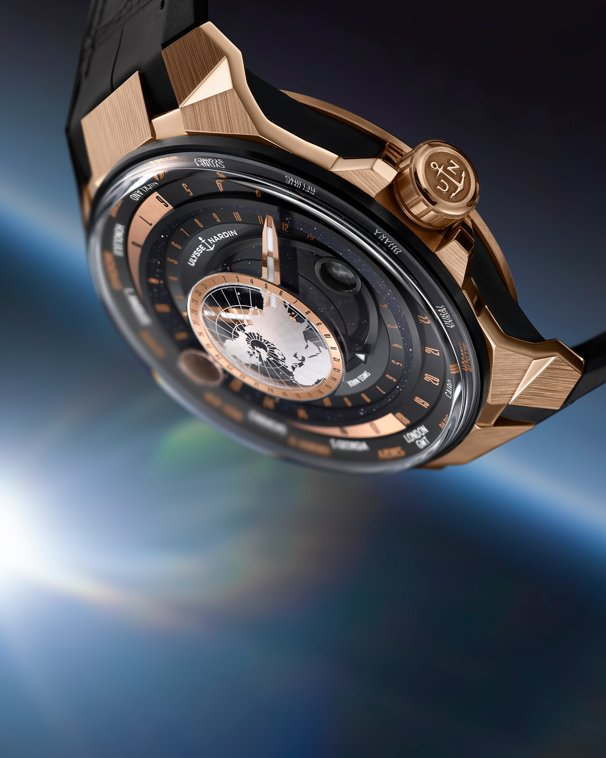 Close view of the crown engraved with the Ulysse Nardin anchor beside the floating three-dimensional Northern Hemisphere and the moon indication over the aventurine dial