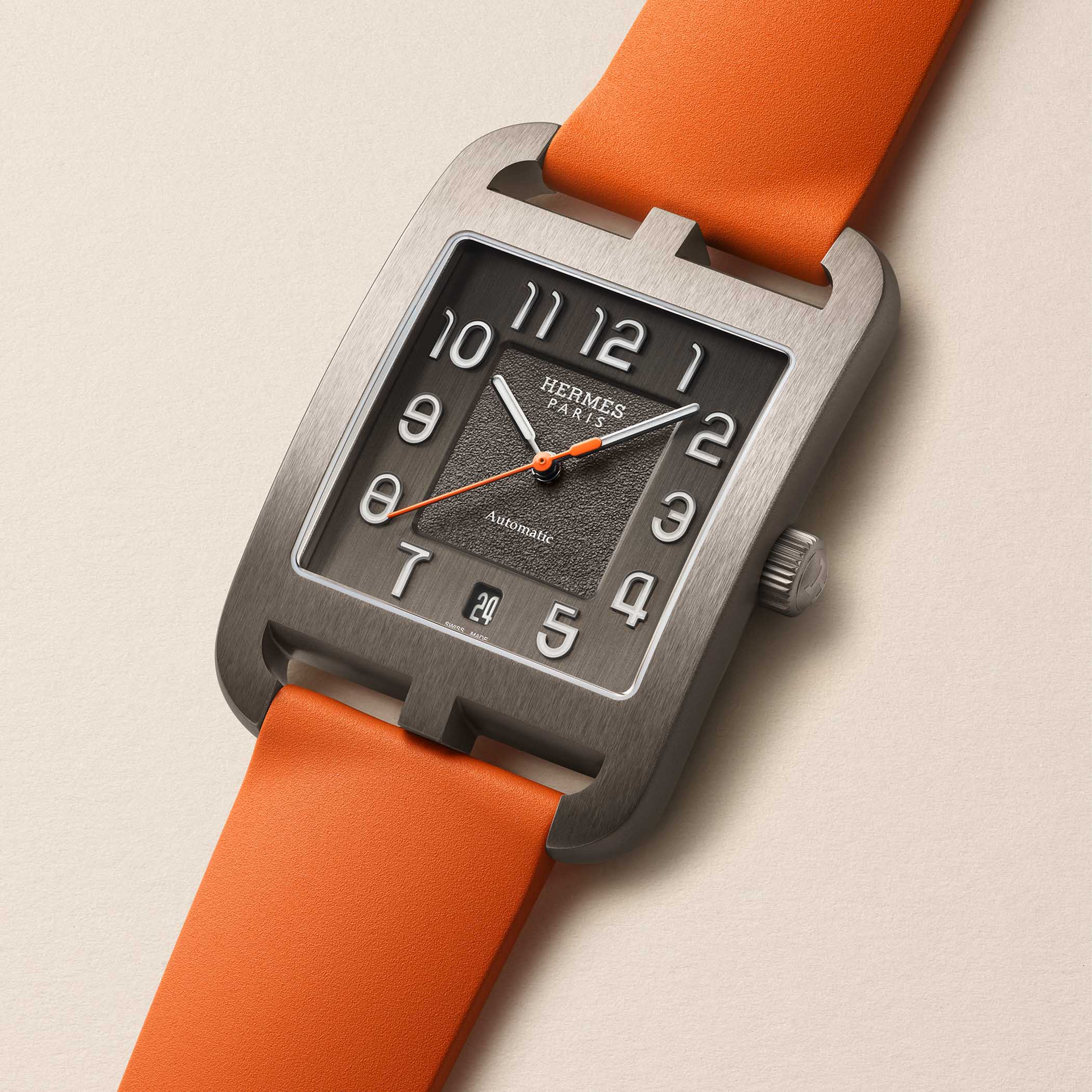 The Cape Cod Titanium on an orange rubber strap, showing the quick-change interchangeable strap system