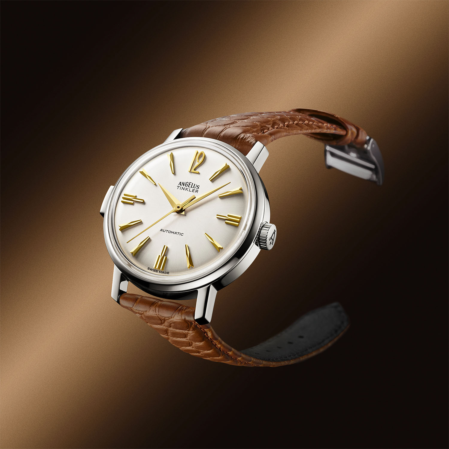 Angelus Tinkler 1958 in steel photographed at an angle on a saddle brown alligator strap, showing the polished case profile and the steel pin buckle