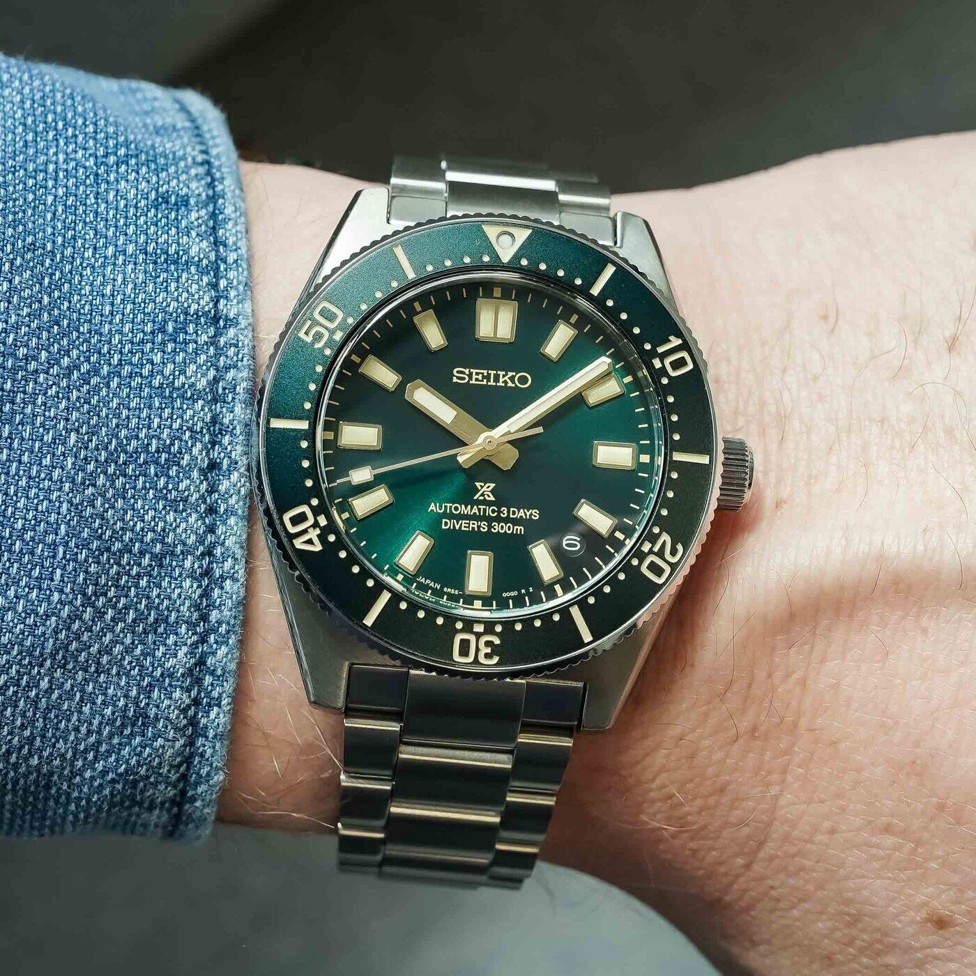 Seiko Prospex 1965 Heritage Diver HBC010 worn under a denim cuff, dial and bezel head-on, showing how the 40mm case sits on the wrist on its steel bracelet