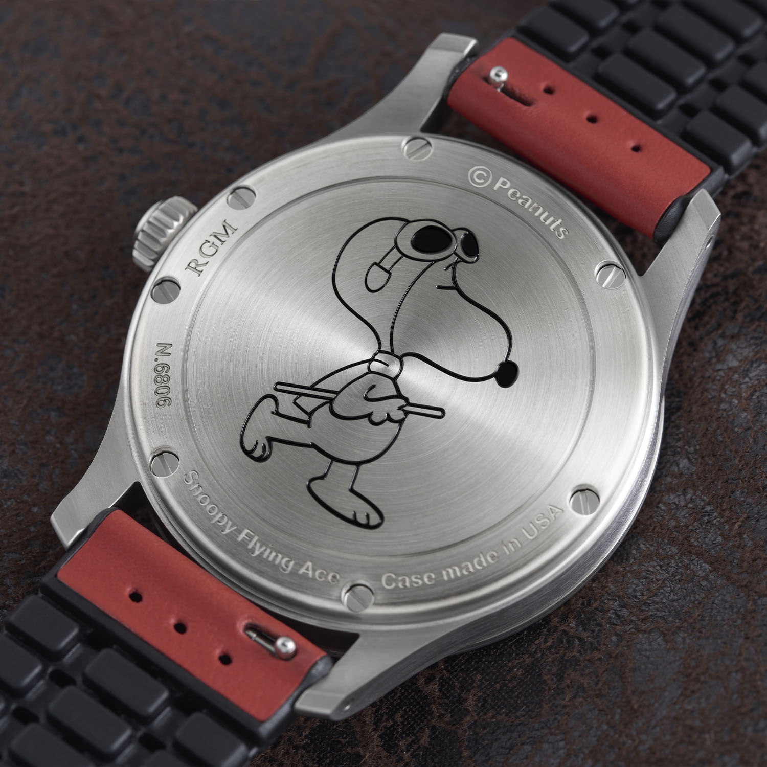 Brushed steel caseback of the RGM Model 151 engraved with a walking Snoopy Flying Ace, the words Snoopy Flying Ace and Case made in USA, the RGM name, a copyright Peanuts mark and the serial N.6089