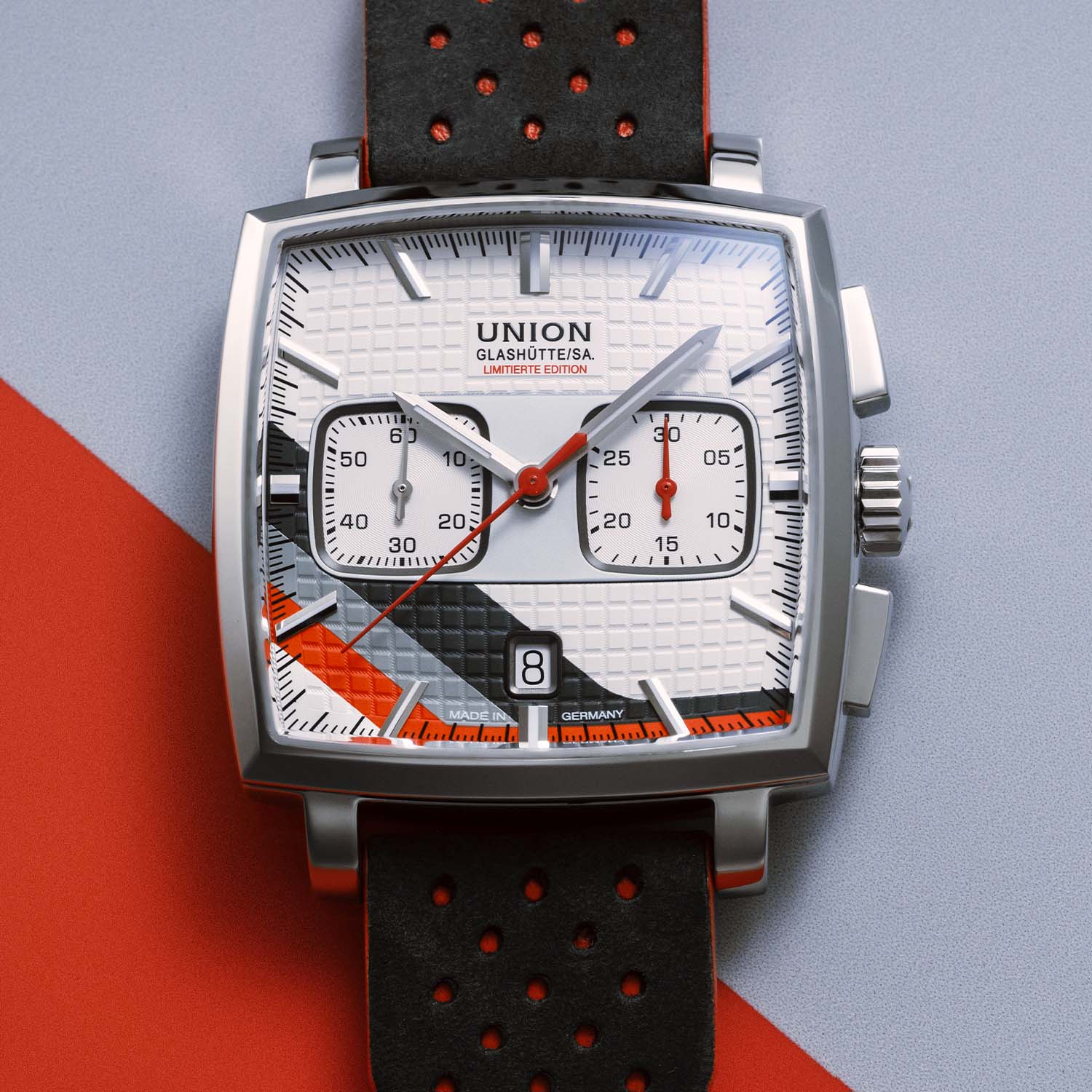 Dial macro of the Union Glashütte Averin Sachsen Classic 2026, white embossed tile-pattern dial with a diagonal red, black and grey stripe, square small-seconds and 30-minute chronograph registers, red central chronograph hand and date at six