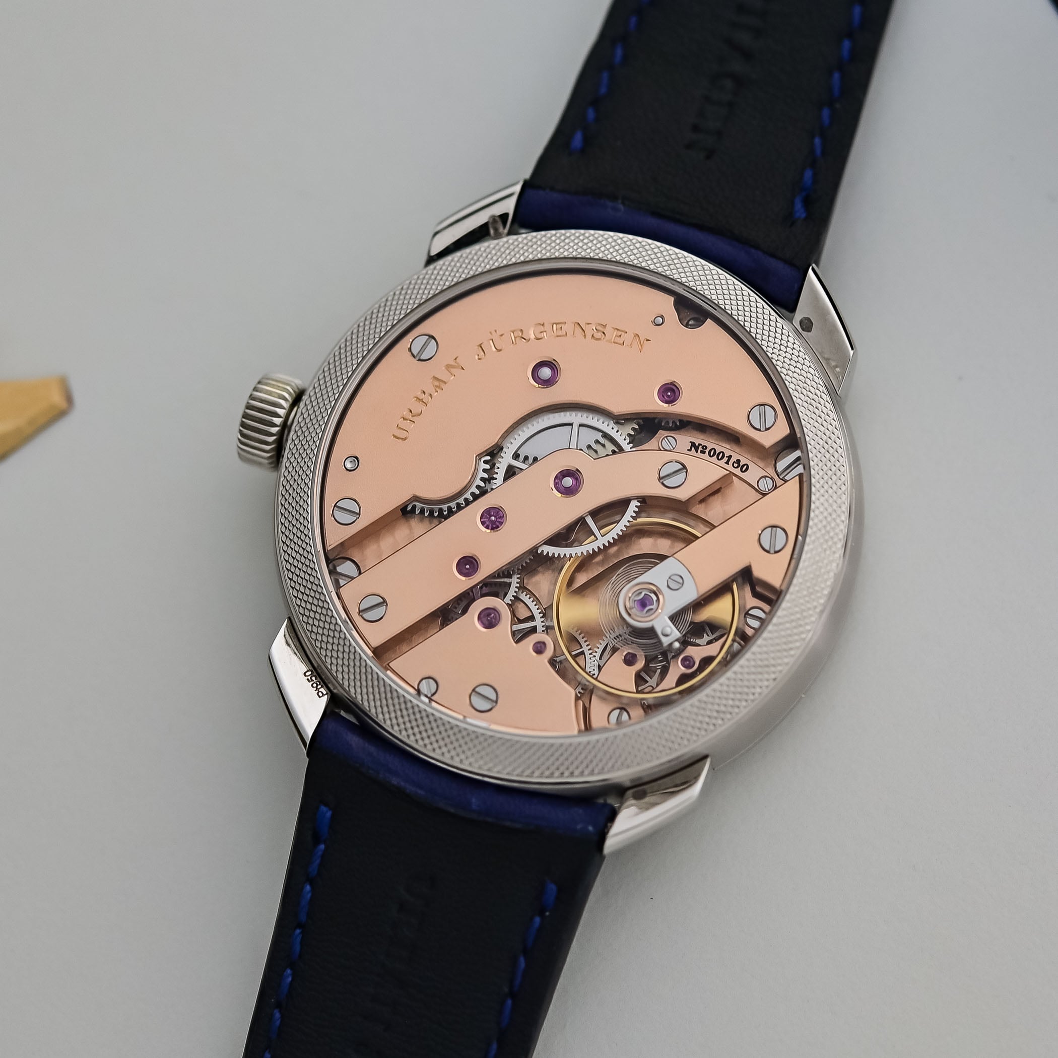 Sapphire caseback of the platinum UJ-2 numbered 00180, showing the hand-wound calibre UJ-2 with rose-gold-plated bridges, mirror-polished screws and the free-sprung balance