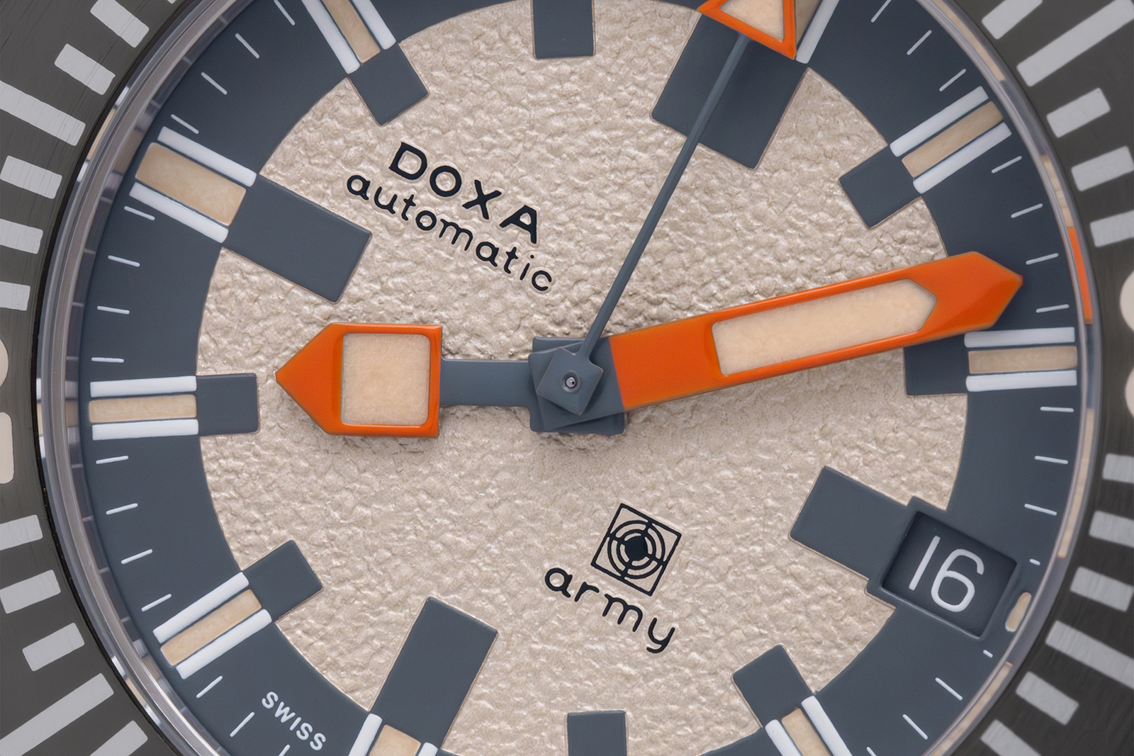 The DOXA SUB Army 200T for Hodinkee at a three-quarter angle resting on a dive-camera housing, cushion steel case, grey anodised bezel and grey rubber strap