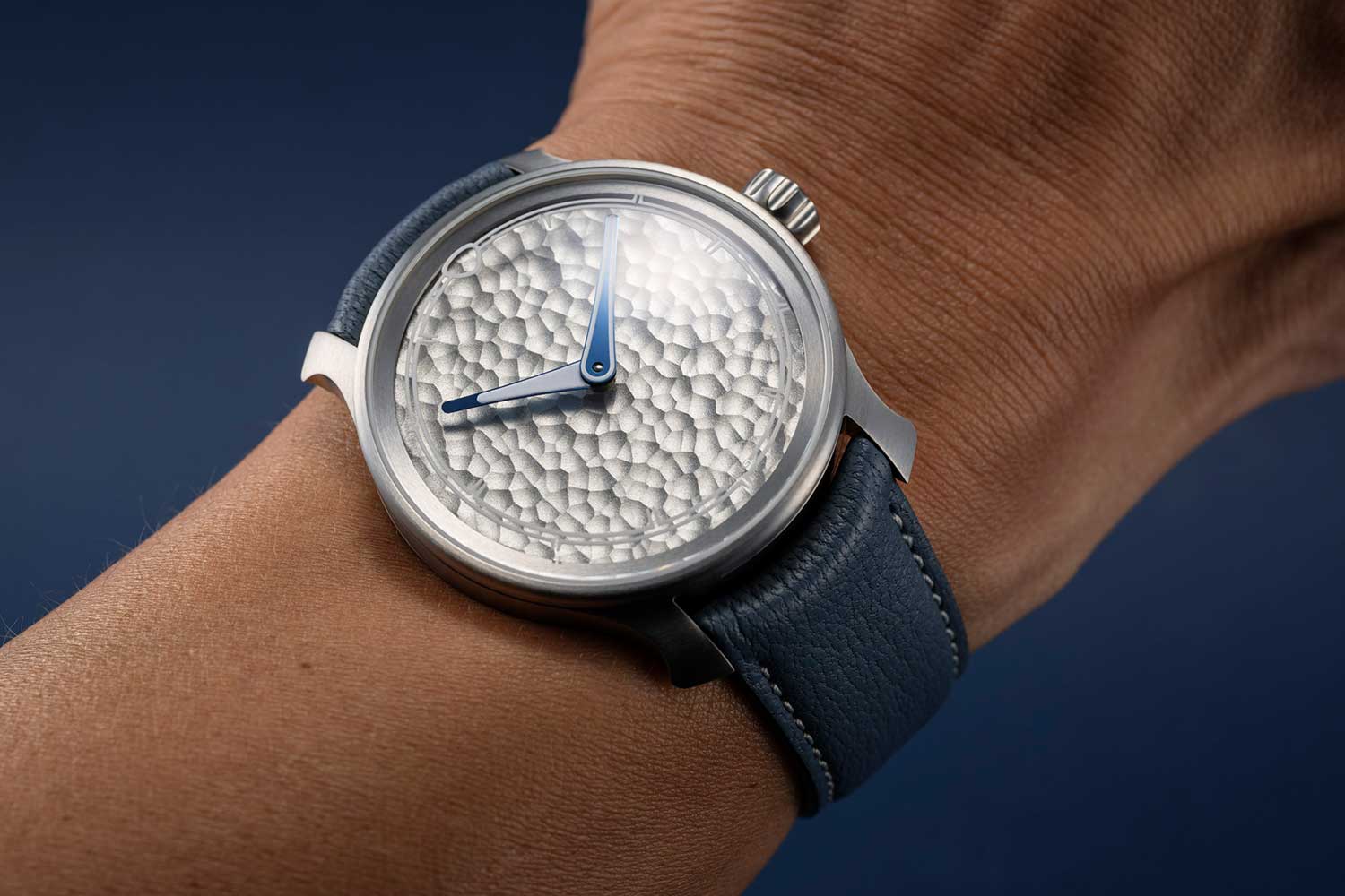 The MING 37.06 Royal Selangor on the wrist, brushed grade-2 titanium case and hammered pewter dial on a blue-grey leather strap