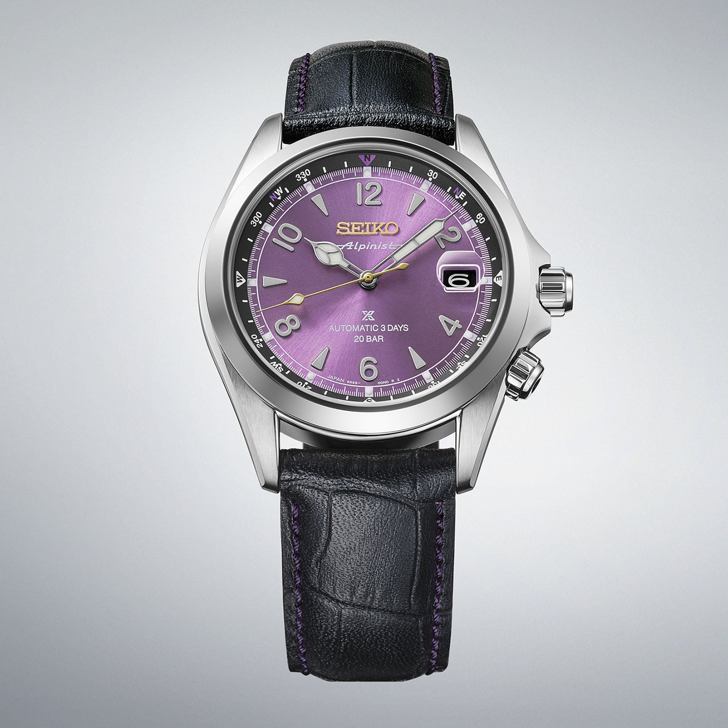 The Seiko Alpinist HBC006 with a pale sunray purple dial, inner compass bezel, gold Seiko and Alpinist text and a black crocodile-pattern leather strap with purple stitching, marked Automatic 3 Days 20 BAR
