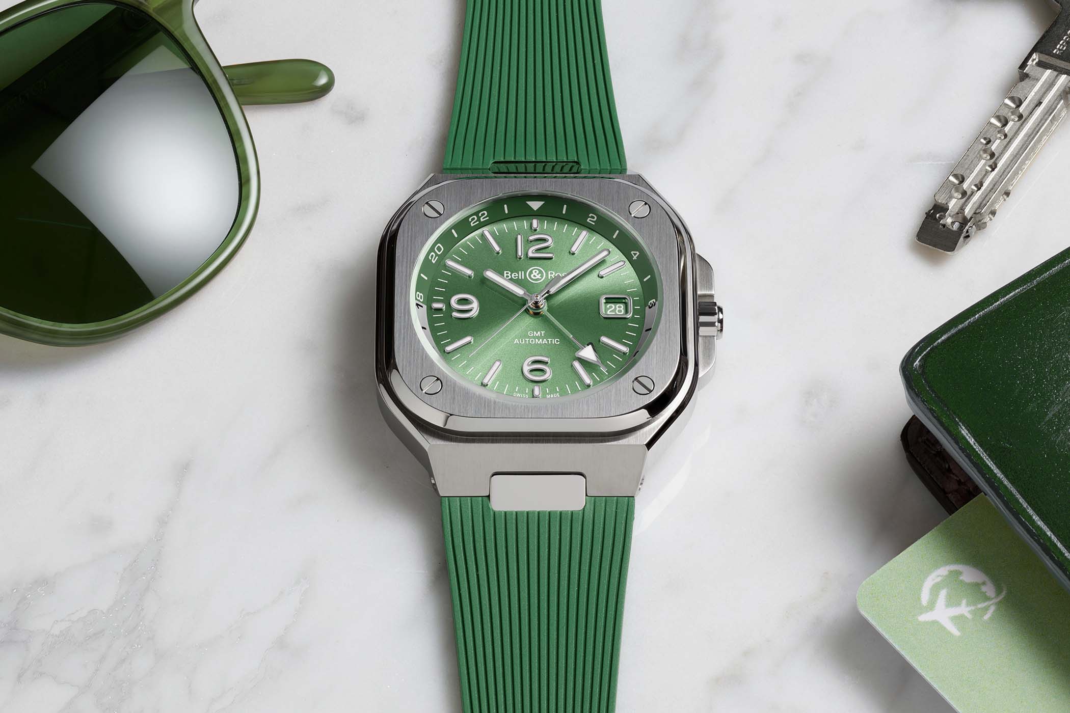 Bell & Ross BR-05 GMT Green Steel with a sunray sage green dial and a green and silver-grey 24-hour flange in a steel circle-in-a-square case, shown on its green rubber strap