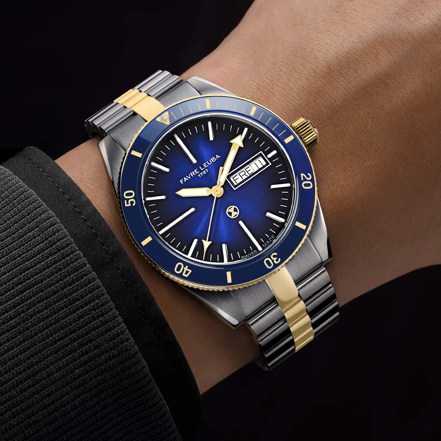 The green sunray gradient version shown flat with its two-tone steel and gold bracelet alongside a matching green rubber quick-change strap