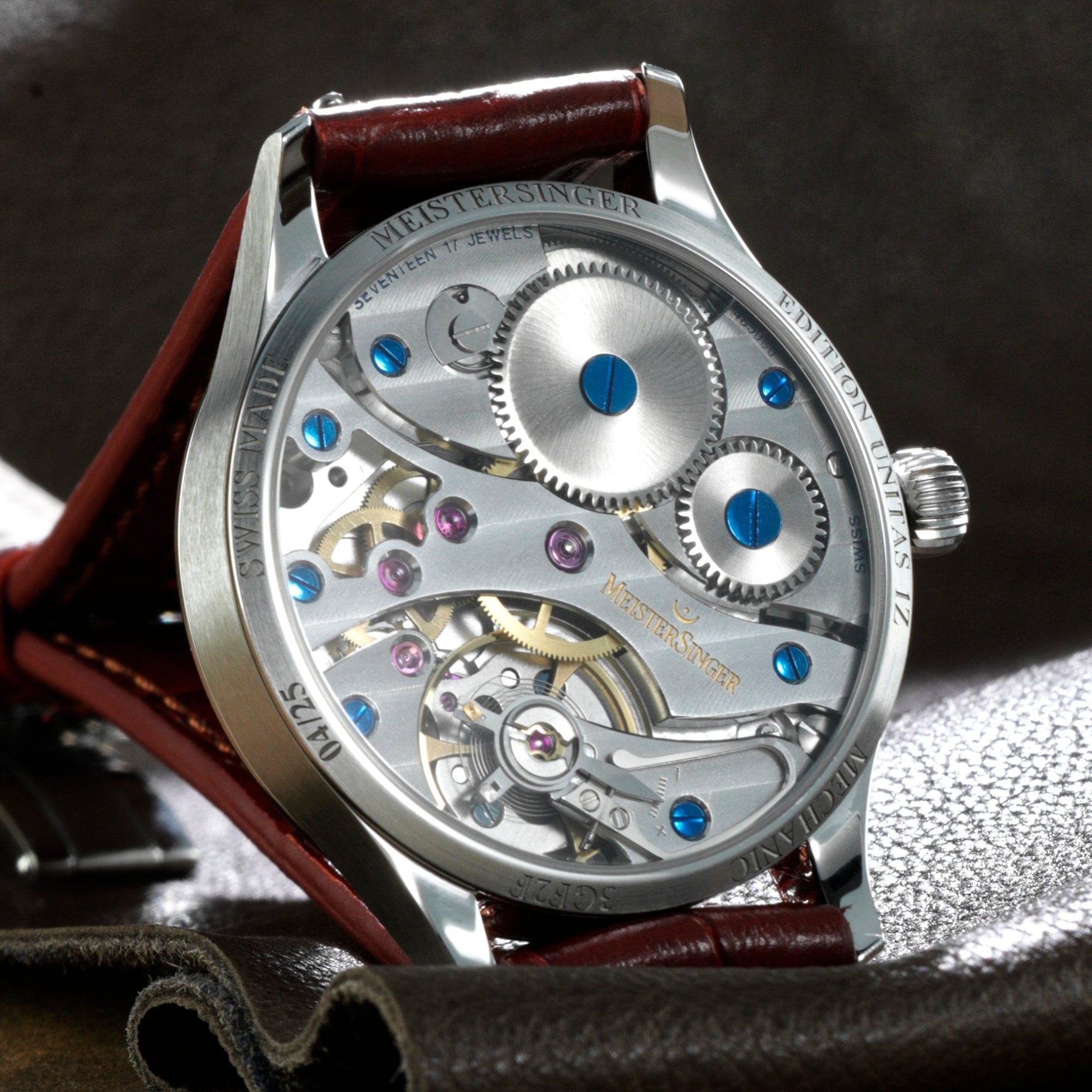 Sapphire caseback of the Edition Unitas 1Z Blue numbered 04/25, showing the hand-wound ETA/Unitas 6497 with Geneva stripes, blued screws and a swan-neck fine-adjustment regulator, engraved MeisterSinger Swiss Made Edition Unitas 1Z