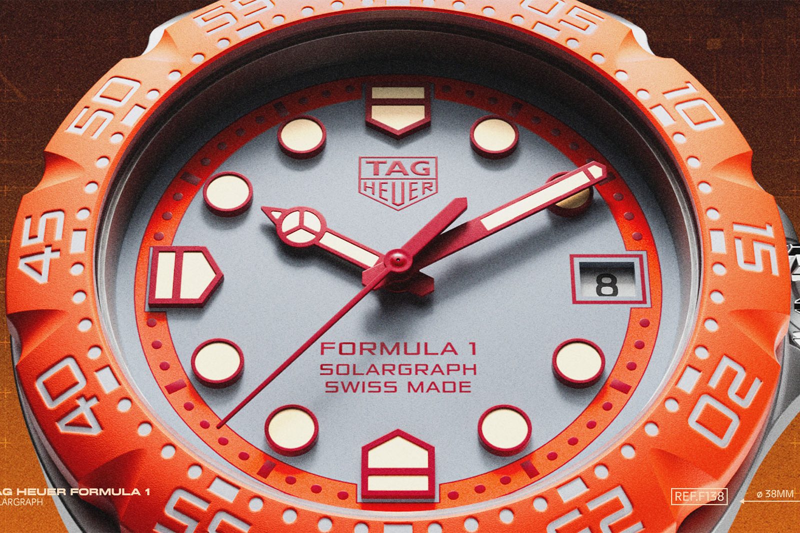 Macro of the TAG Heuer Formula 1 Solargraph dial, a grey opaline face with red lacquered applied markers and hands, the red TAG Heuer shield, an orange TH-Polylight bezel and a date window at three o'clock