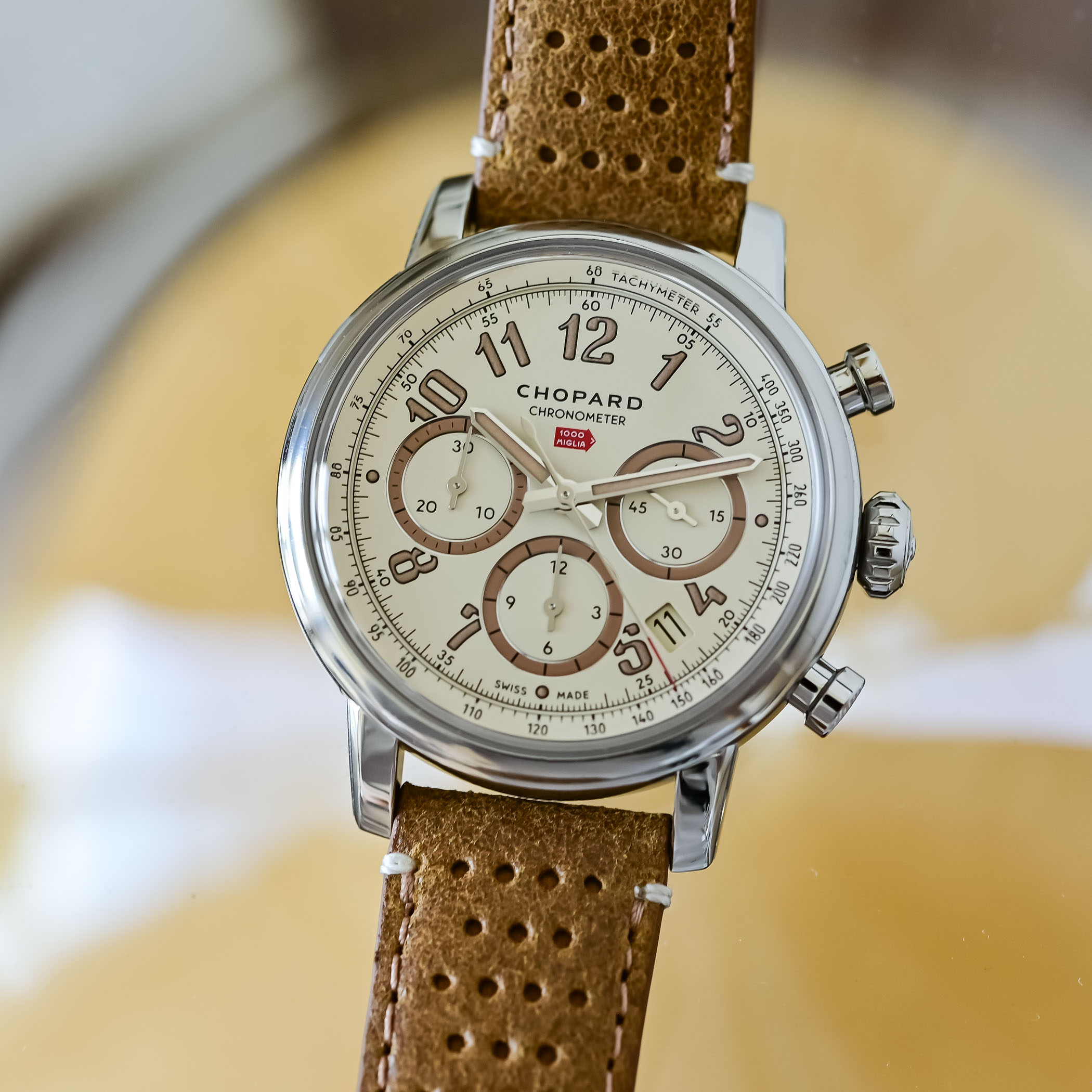 The titanium caseback engraved with a vintage race car climbing the Passo della Raticosa past spectators and a 968-metre altitude road sign, ringed by a 1000 Miglia banner