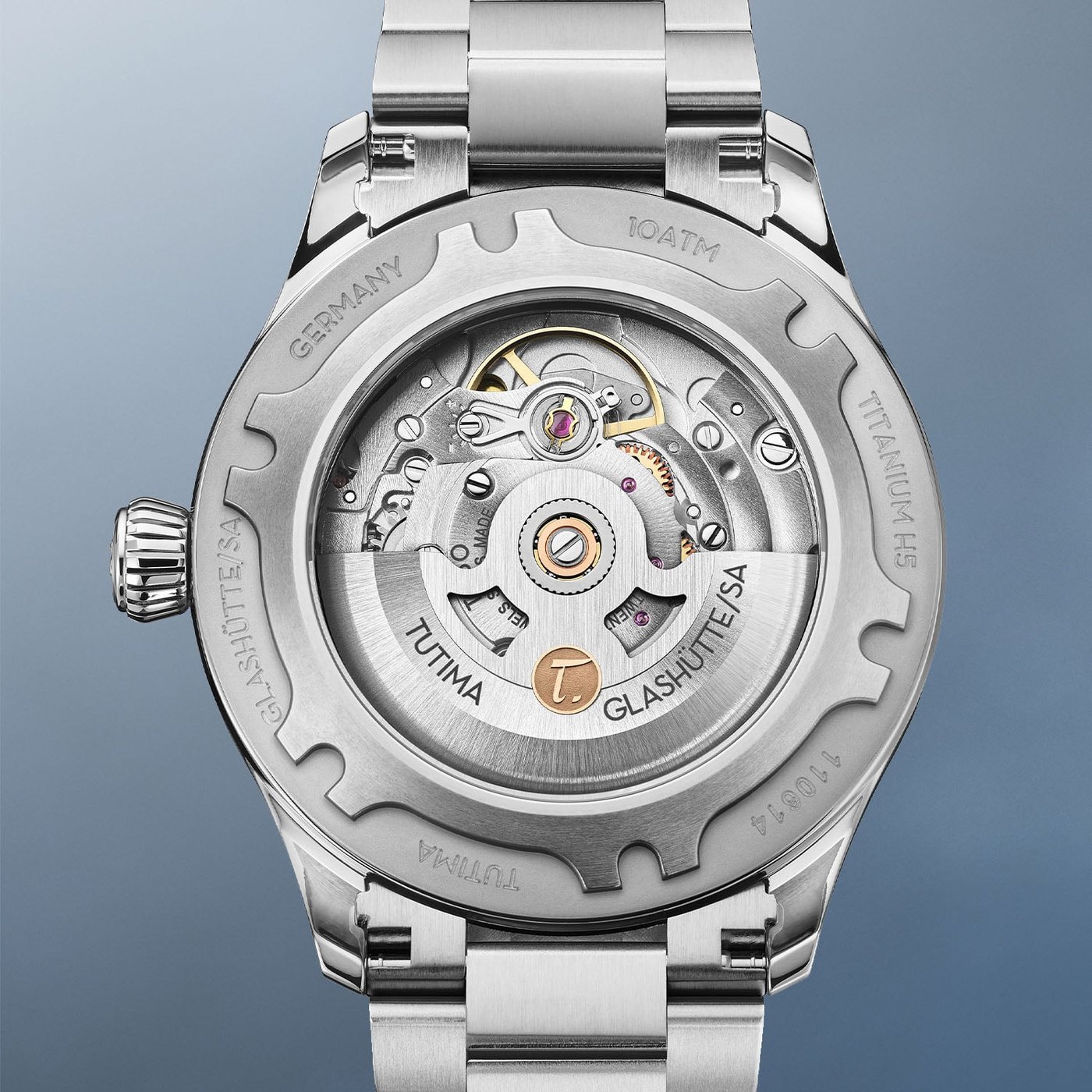 The titanium screw-down caseback of the Flieger T5, its sapphire window over the automatic calibre 330 with a rhodium-plated rotor bearing a gold Tutima T, engraved Titanium H5 and 10 ATM