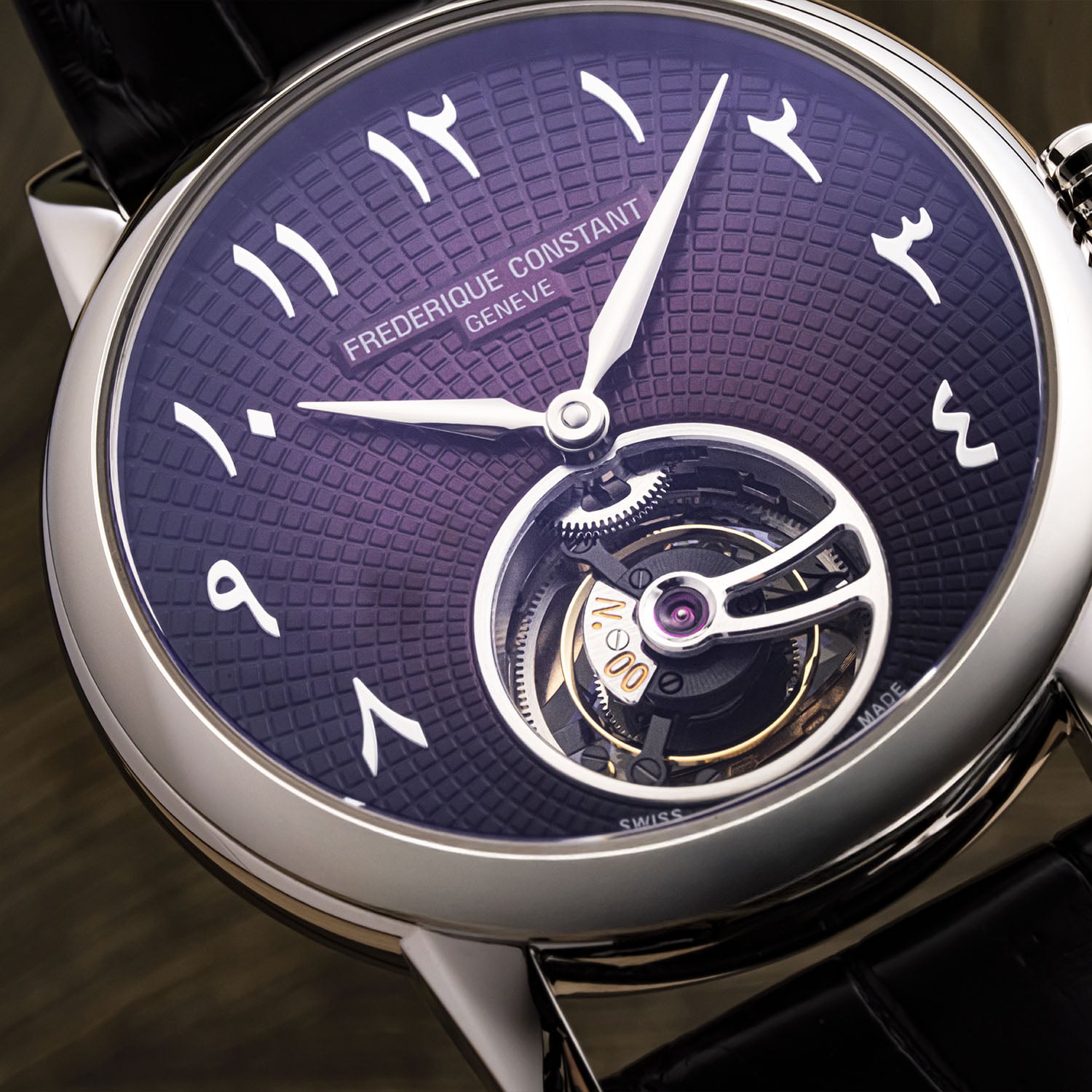 Angled close-up of the Julie's tourbillon at six, its upper cage coated black over the openworked FC-980-4, the burgundy guilloché and Arabic numerals around it