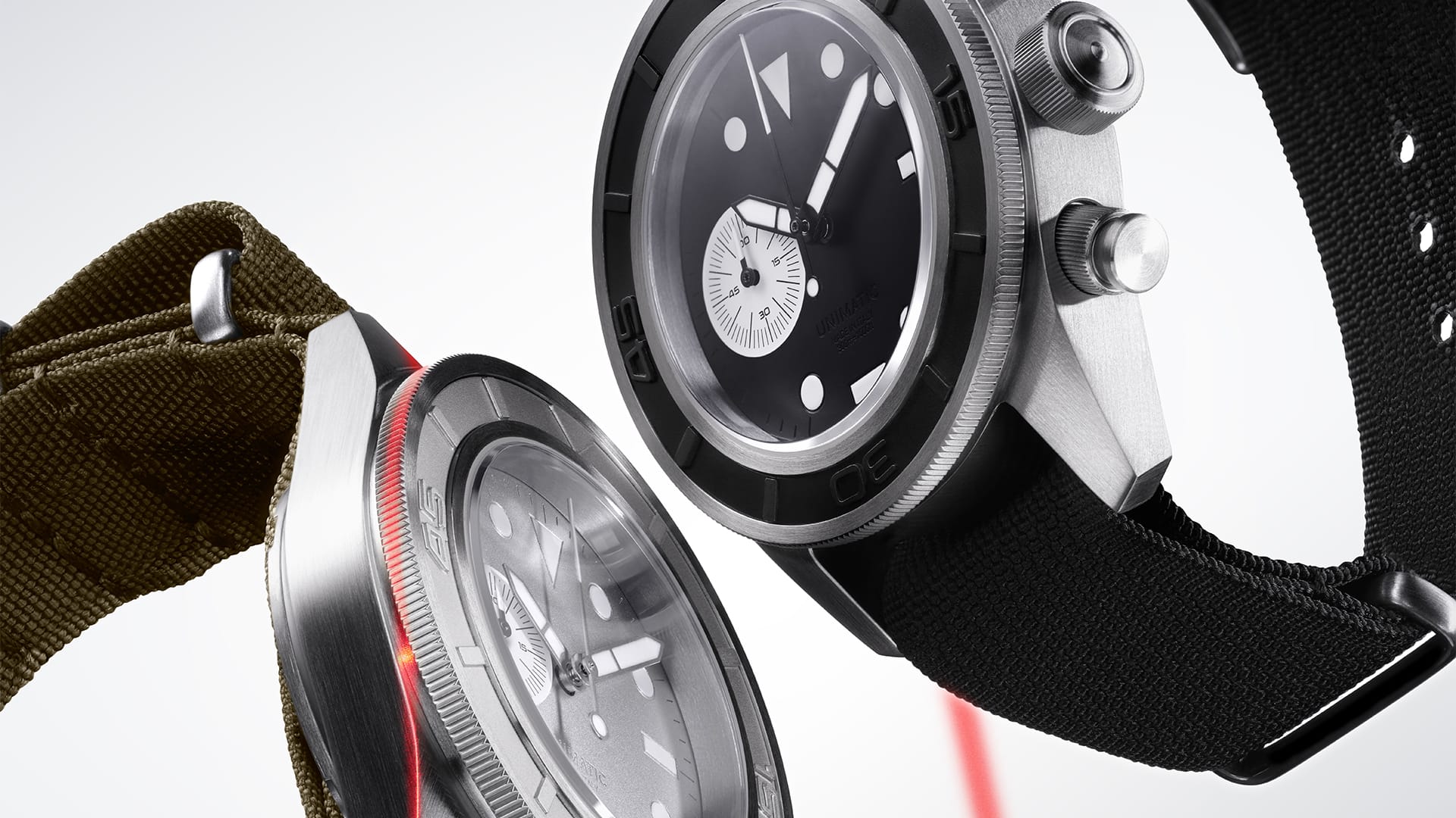 The two Modello Tre chronographs, the black-dial U3-AEB with a contrasting matte-white running-seconds subdial at six and oversized screw-down pushers, beside the aluminium-colour U3-AEG