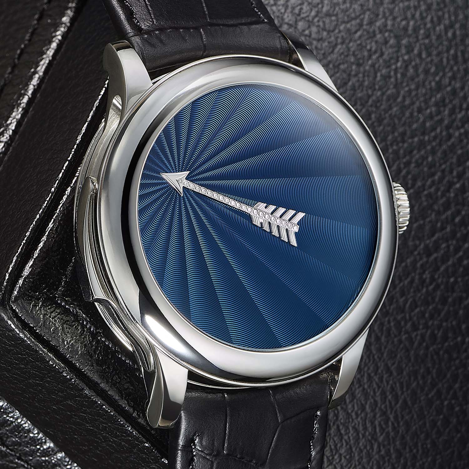 A blue flinque soleil dial version of the Vox Temporis, the rhodium arrow hand fixed over the sunburst guilloche in a white-metal case