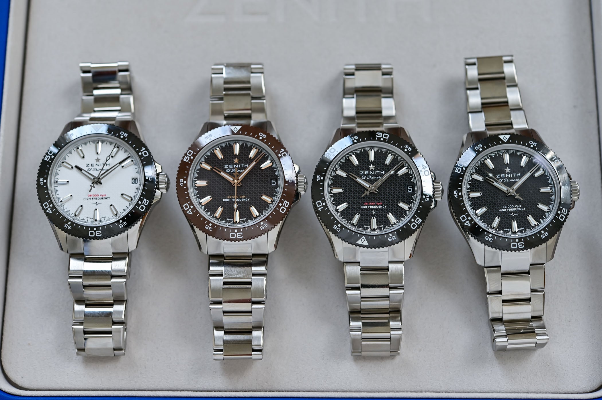 The four Chronomaster Solo Sport references side by side, white, brown and black ceramic dials with a date and a black no-date at the right, on steel bracelets