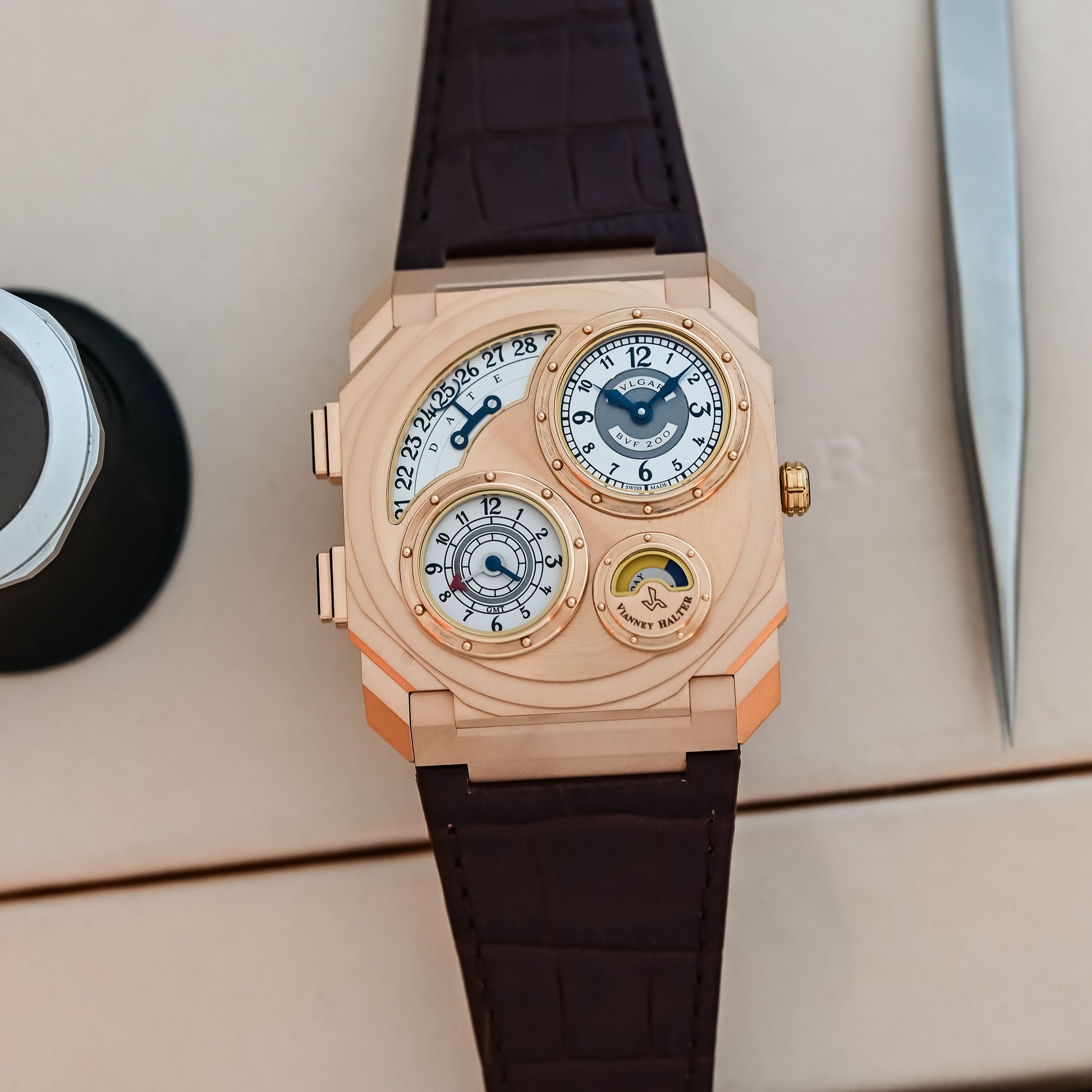 The rose gold version of the Octo Finissimo Dual Time x Vianney Halter on a brown alligator strap, the same four-dial layout in a warmer gold case with satin-polished porthole bezels